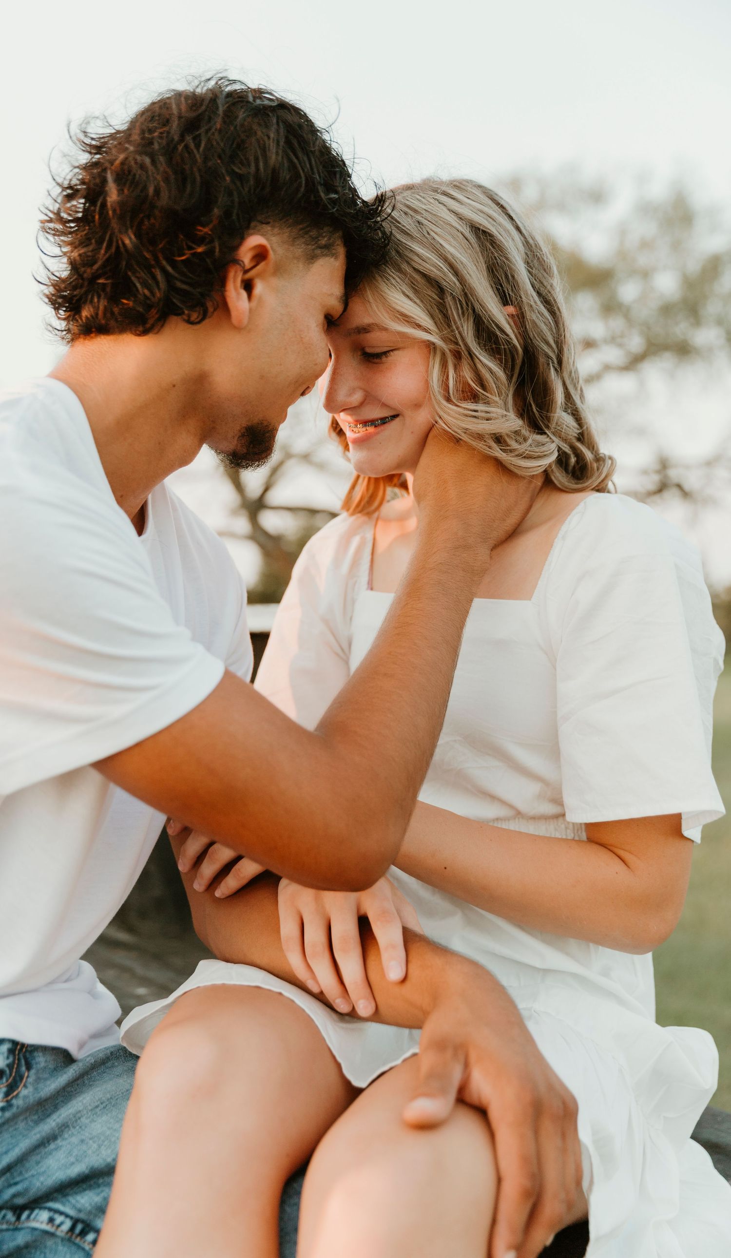 A romantic couple in white shirts sharing intimate moments together in a series of three outdoor photos.