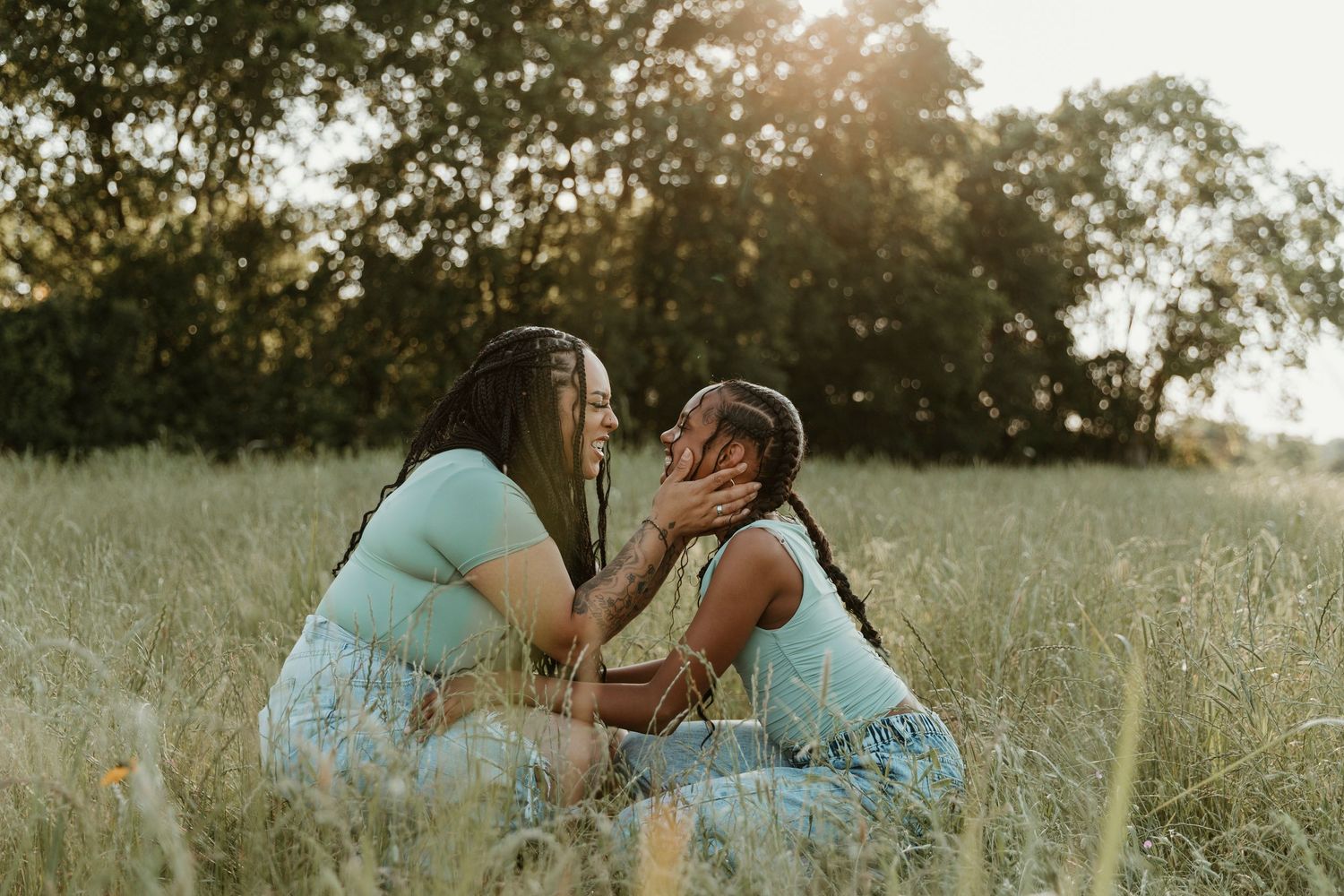 Tender outdoor photo shoot moment captured in natural lighting.