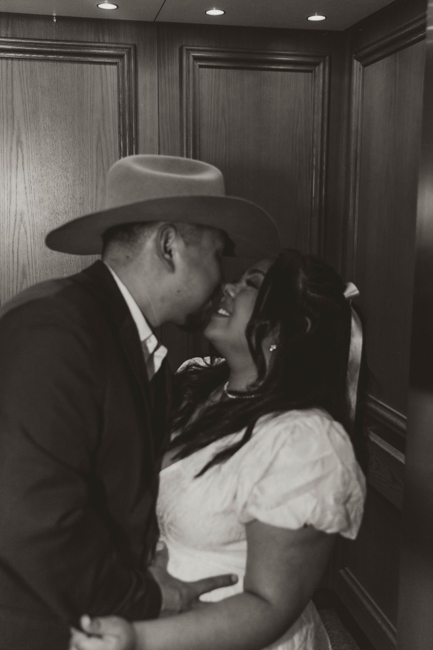 Intimate black and white portrait of newlyweds sharing romantic moment.