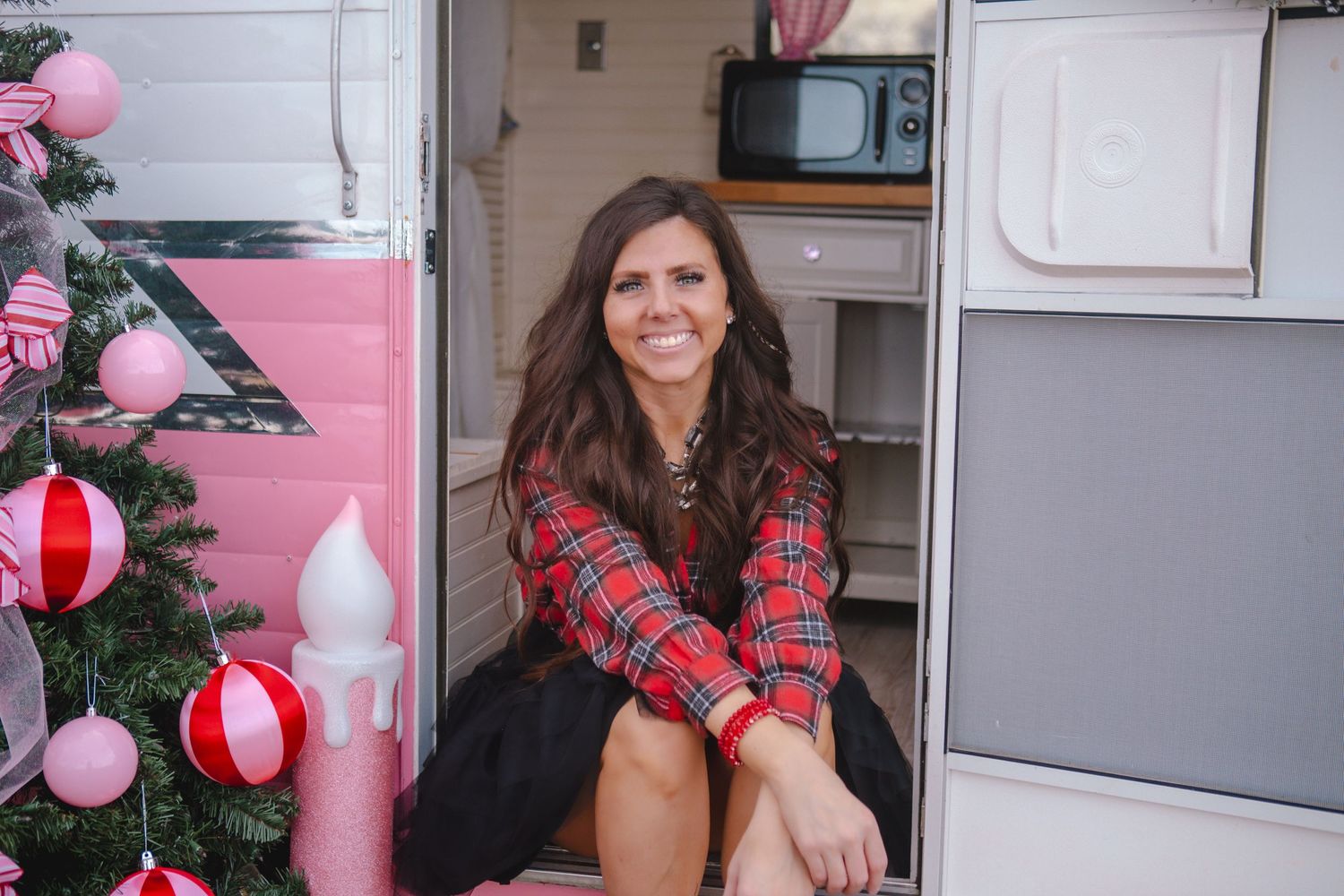 Holiday decorated room with plaid decor and pink balloons creating festive atmosphere.