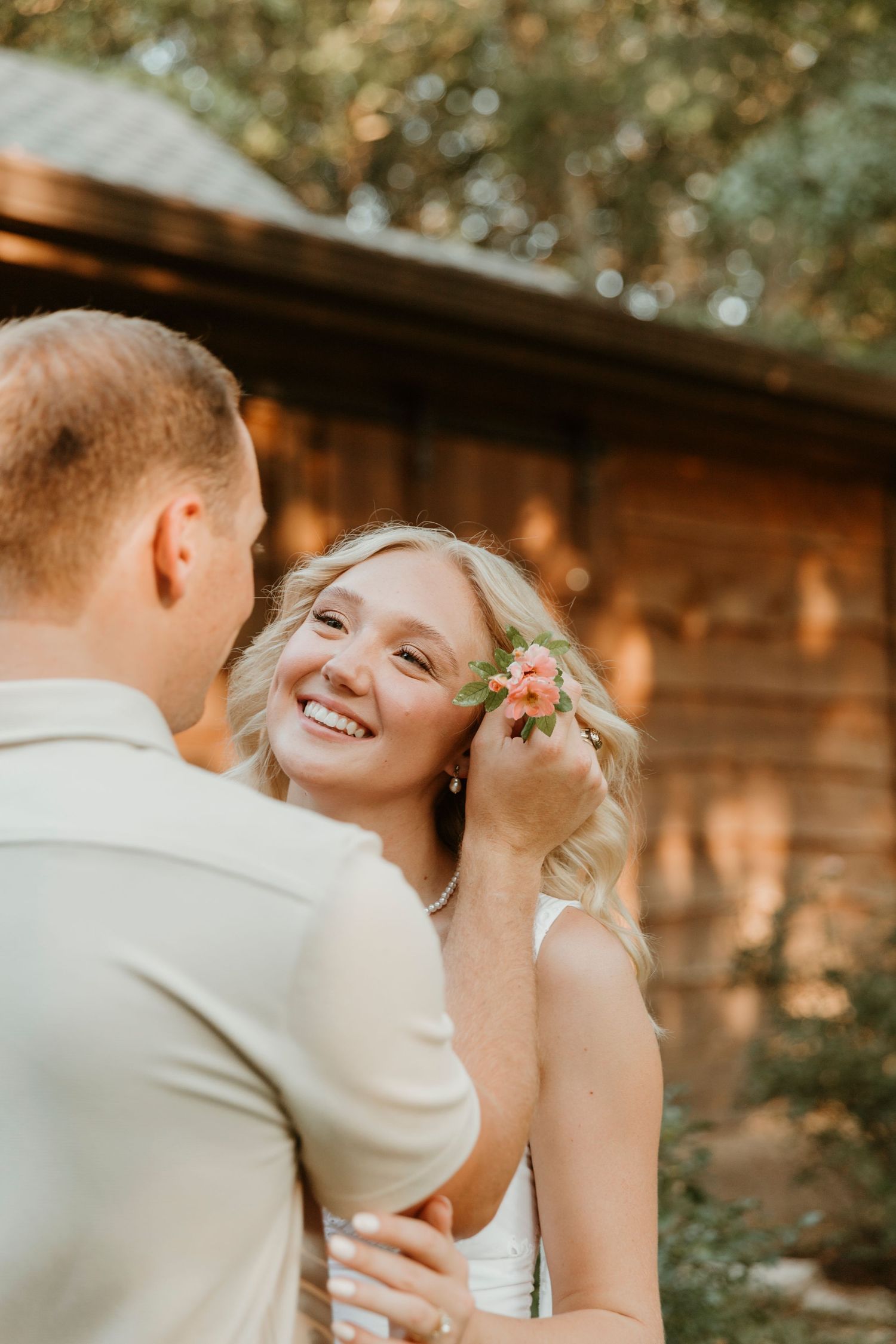 A tender moment shared between a couple during sunset with warm golden lighting.