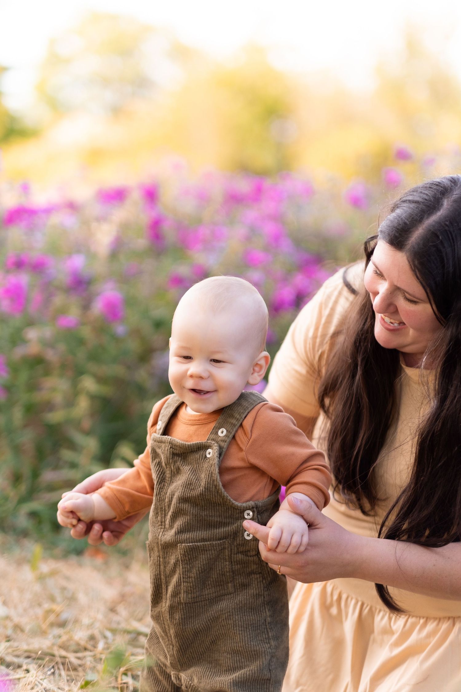 A collage of four tender moments captured in an outdoor setting with purple flowers in the background.