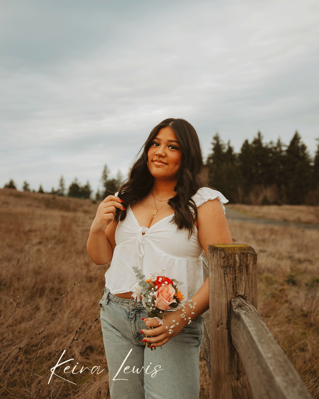 Woman in white dress sitting on wooden fence in golden field during sunset with mushroom decor.