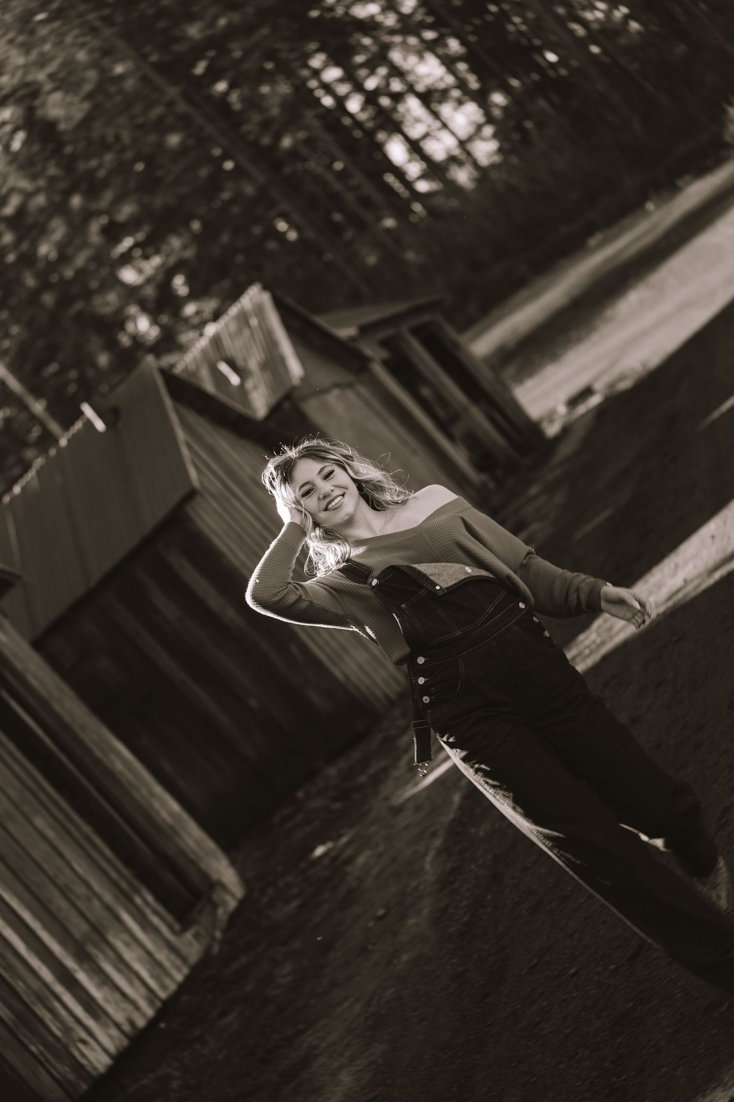Black and white portrait of someone posing outdoors in vintage style.