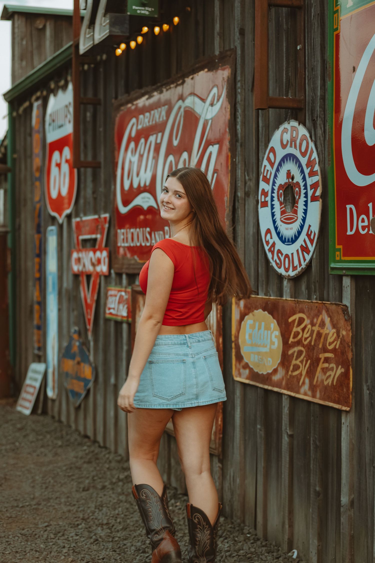 Classic Americana scene with vintage Coca-Cola and Route 66 signs on wooden wall.