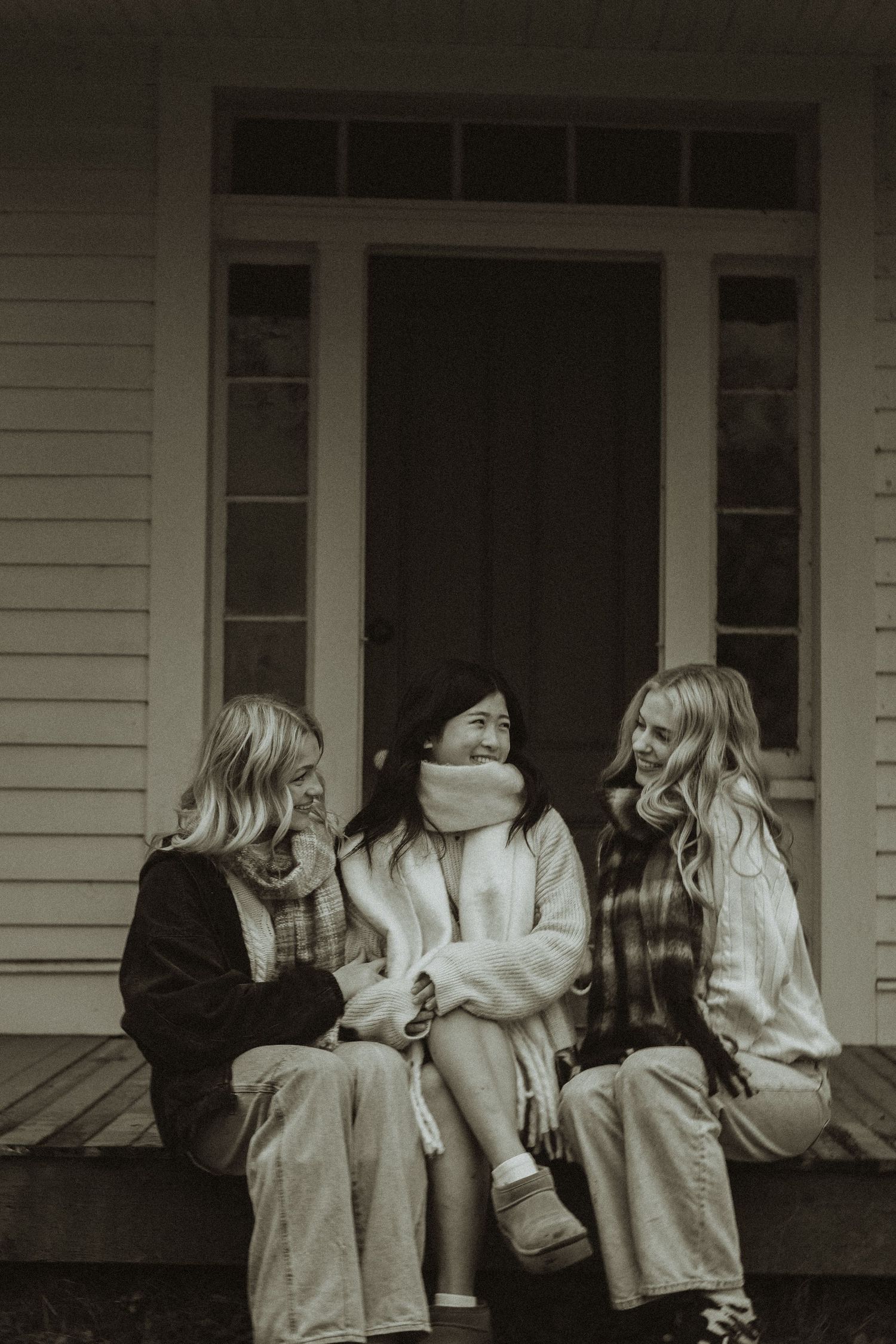 A sequence of black and white photos showing people sitting on a porch in casual clothing.