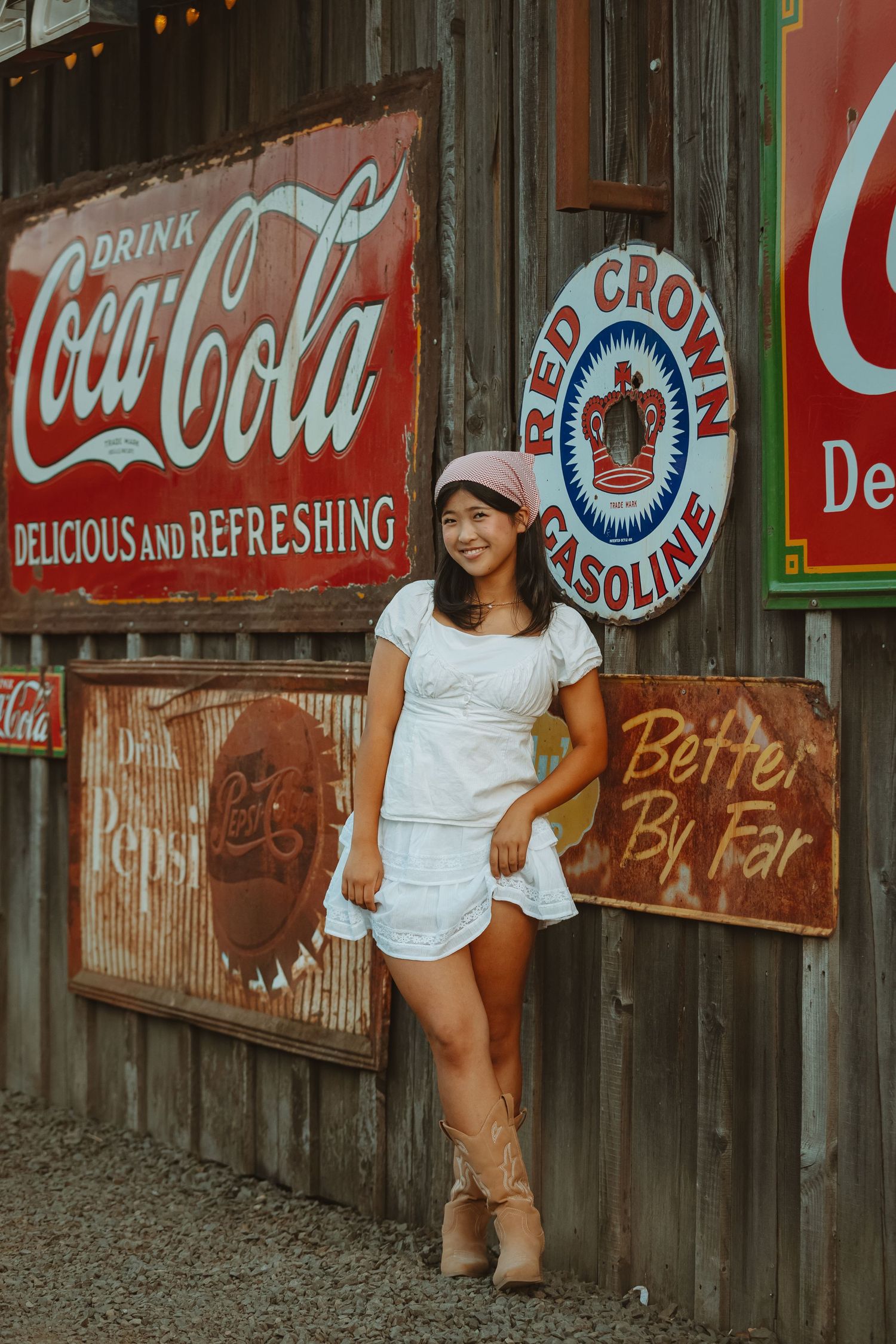 Rustic wall decorated with vintage Coca-Cola and Red Crown Gasoline advertisements.