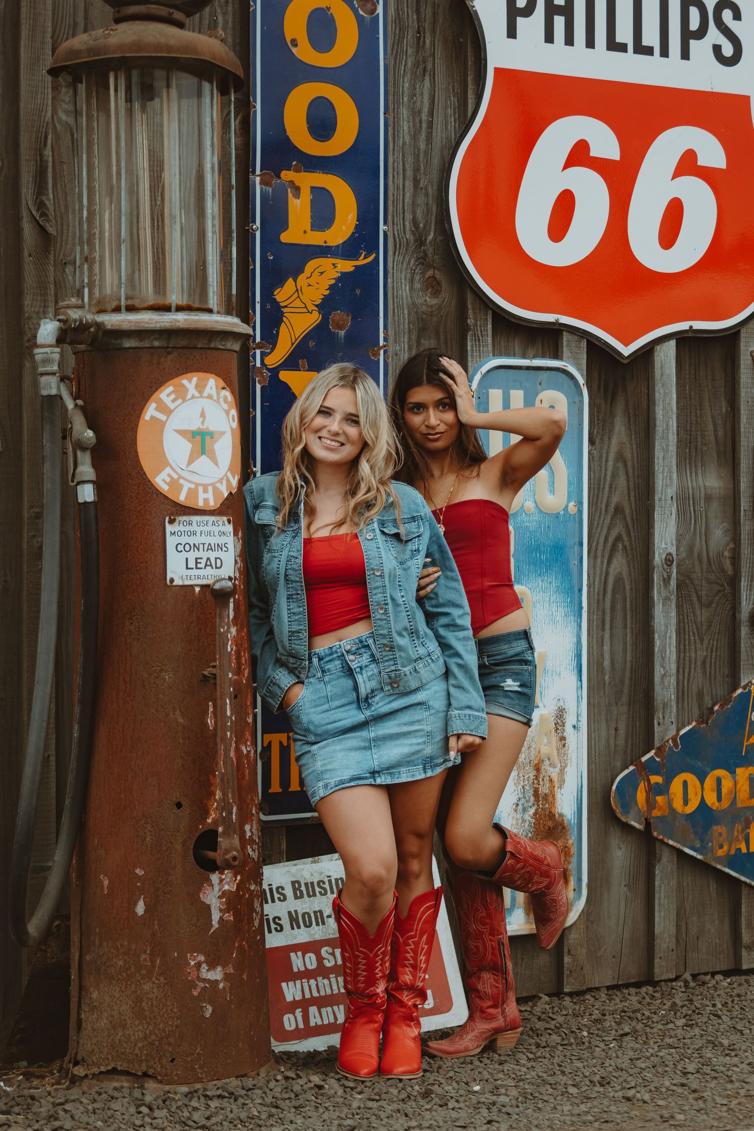Retro Phillips 66 and vintage signage creates nostalgic backdrop against weathered wooden wall.