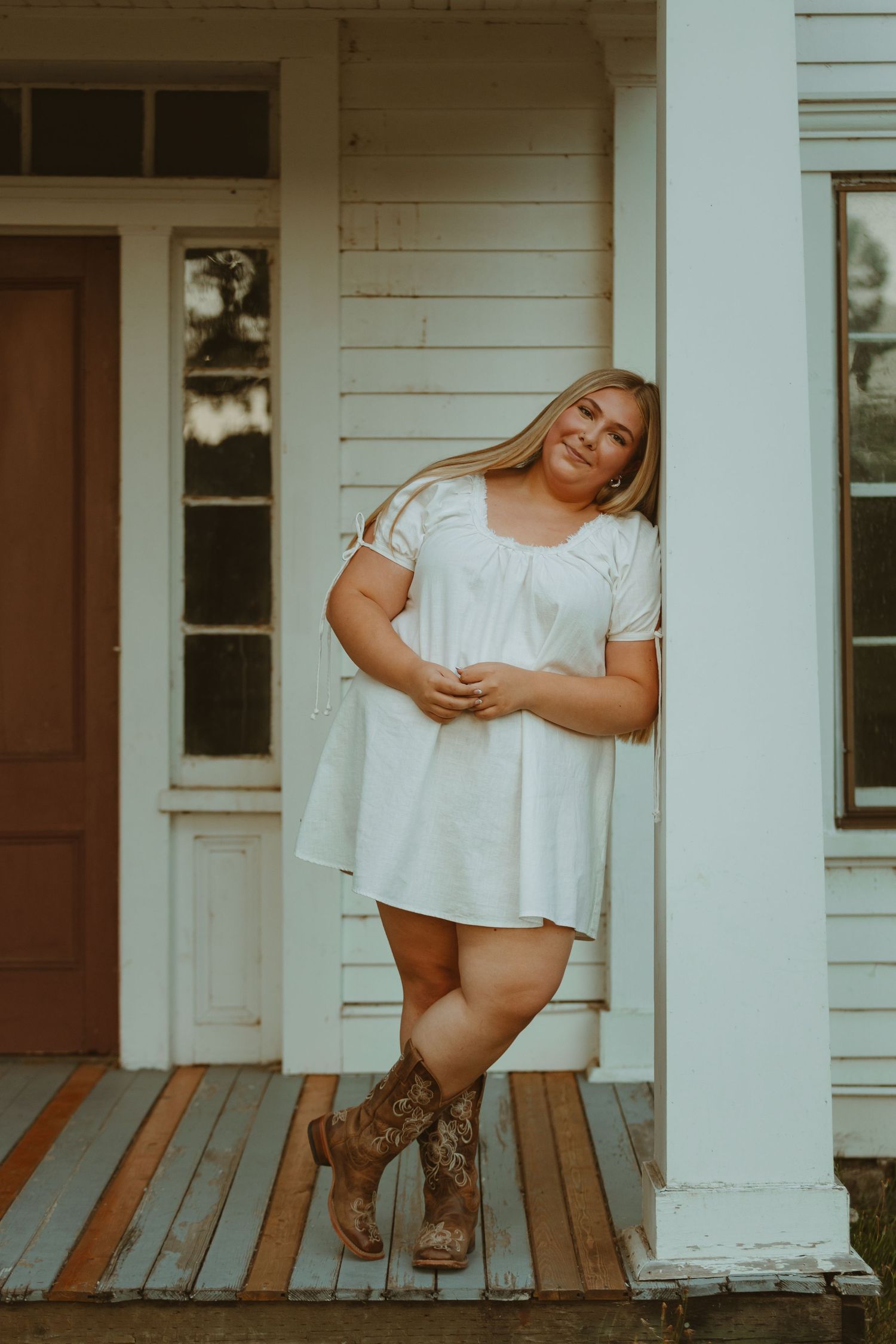 Three connected photos showing someone in a white dress and brown cowboy boots posing on a rustic wooden porch.