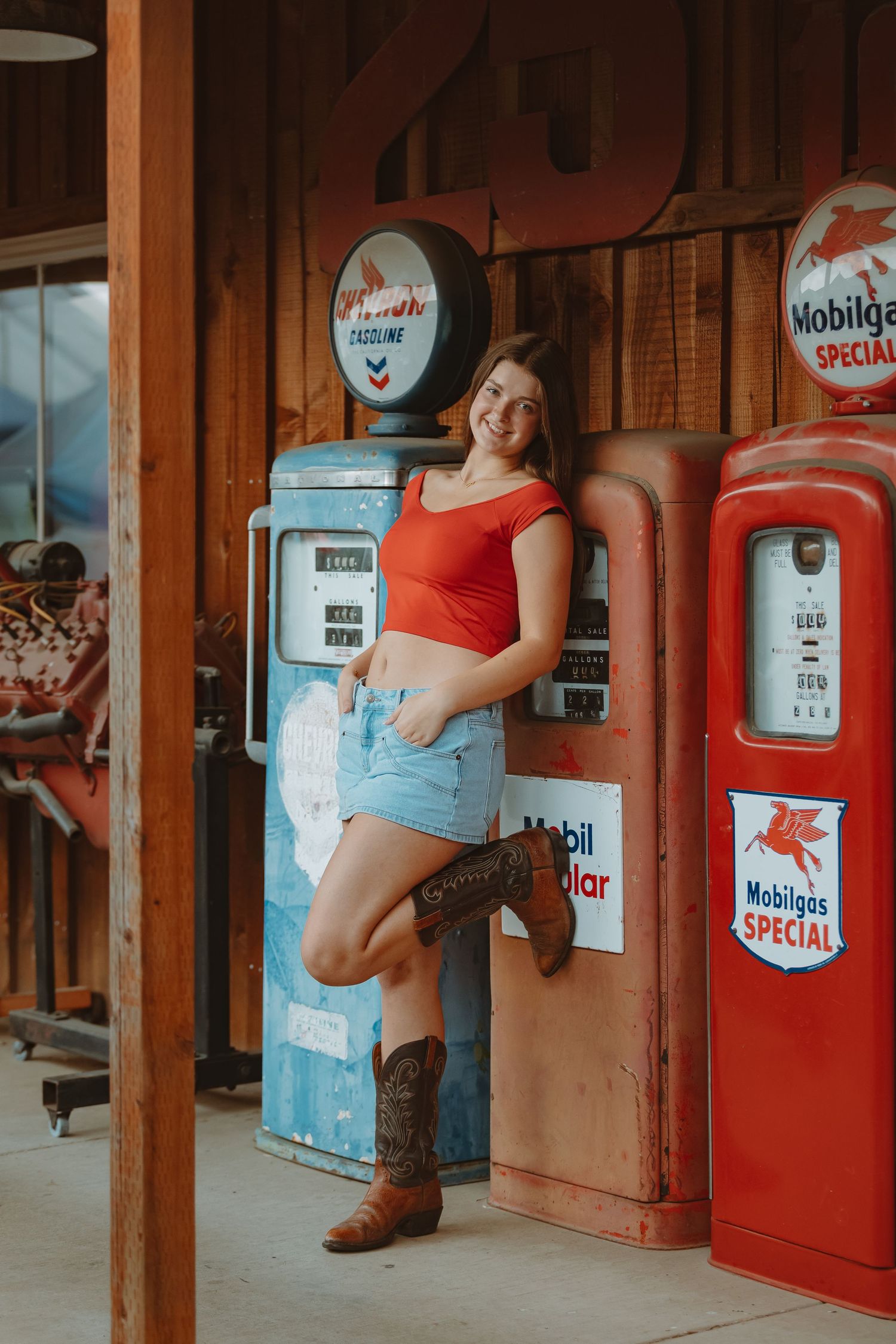 Retro-style photoshoot featuring vintage gas station pumps and classic Mobilgas signage.