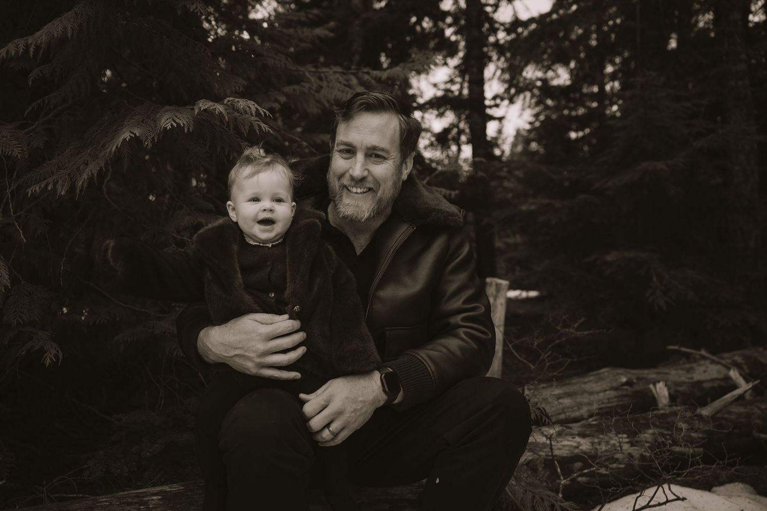 Candid moments of joy captured between family members during a snowy outdoor photo session.