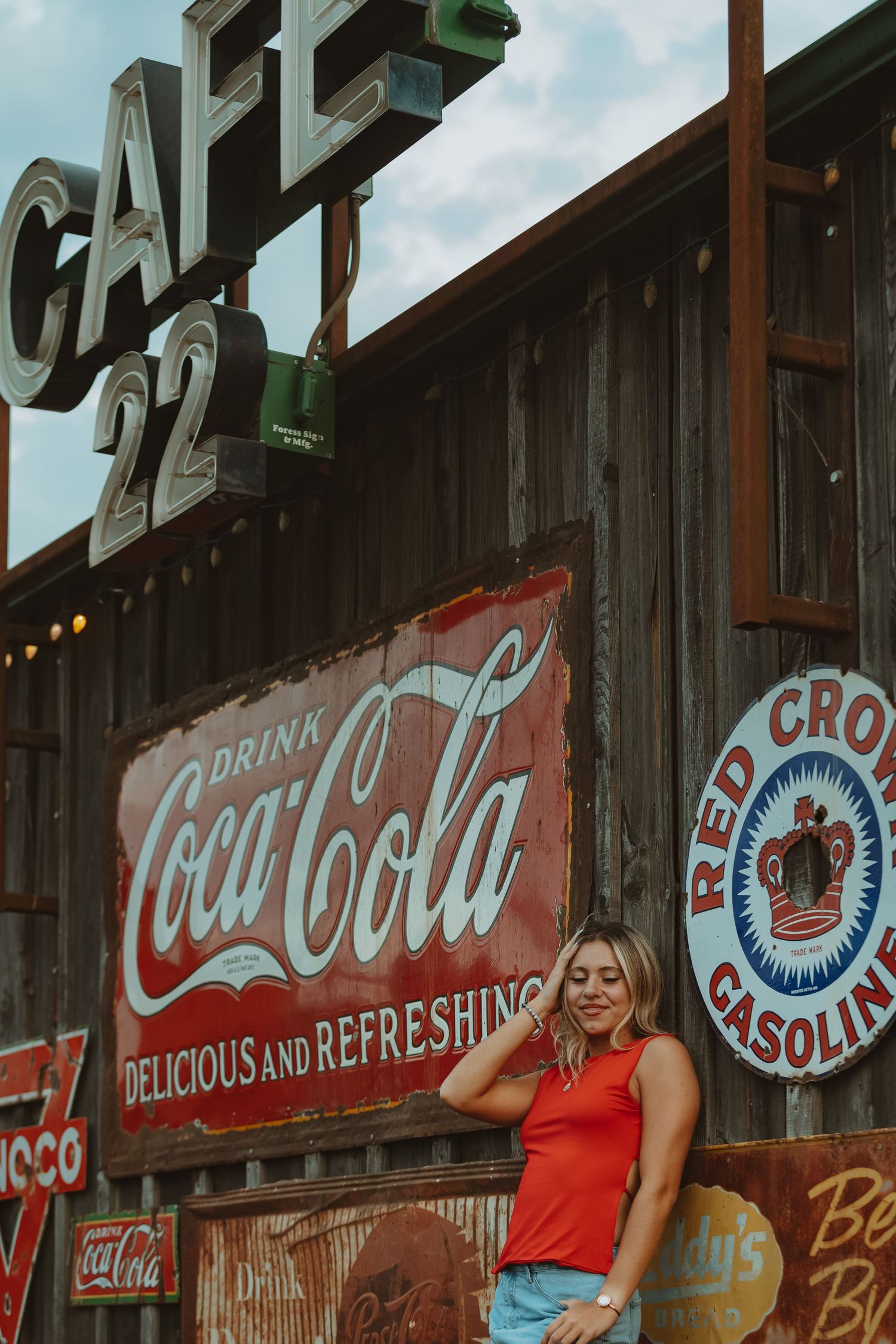Cafe 22 storefront with vintage Coca-Cola advertising and rustic wooden exterior.