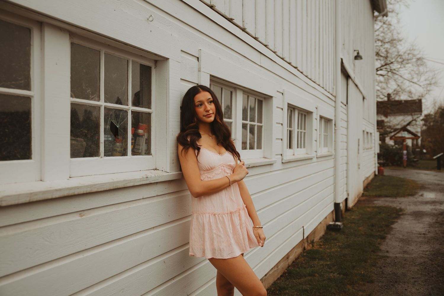 A series of outdoor portraits against a white building wall showing joyful poses and natural lighting.