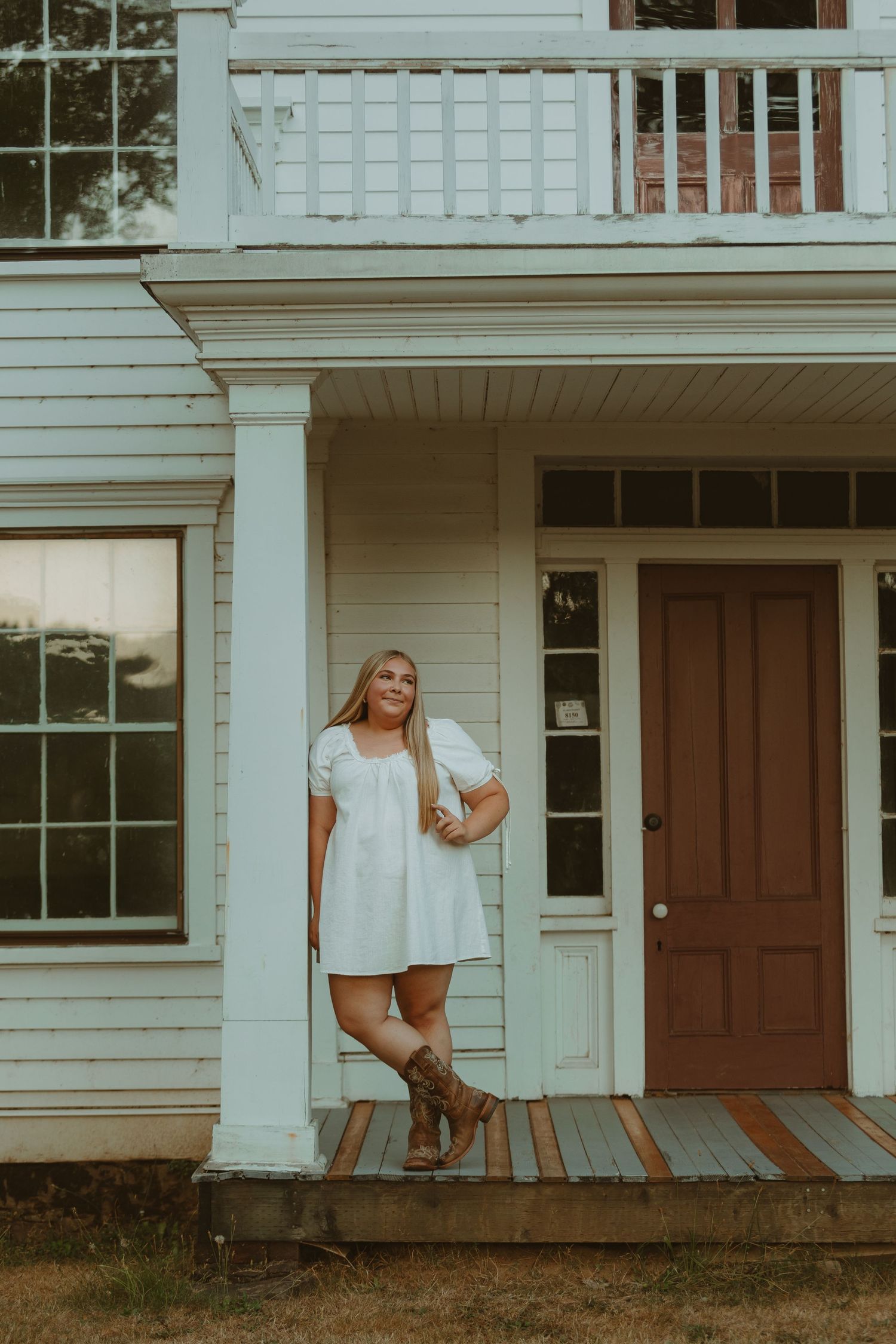 A series of connected photos showing someone in a white dress sitting on the porch of a classic white house.
