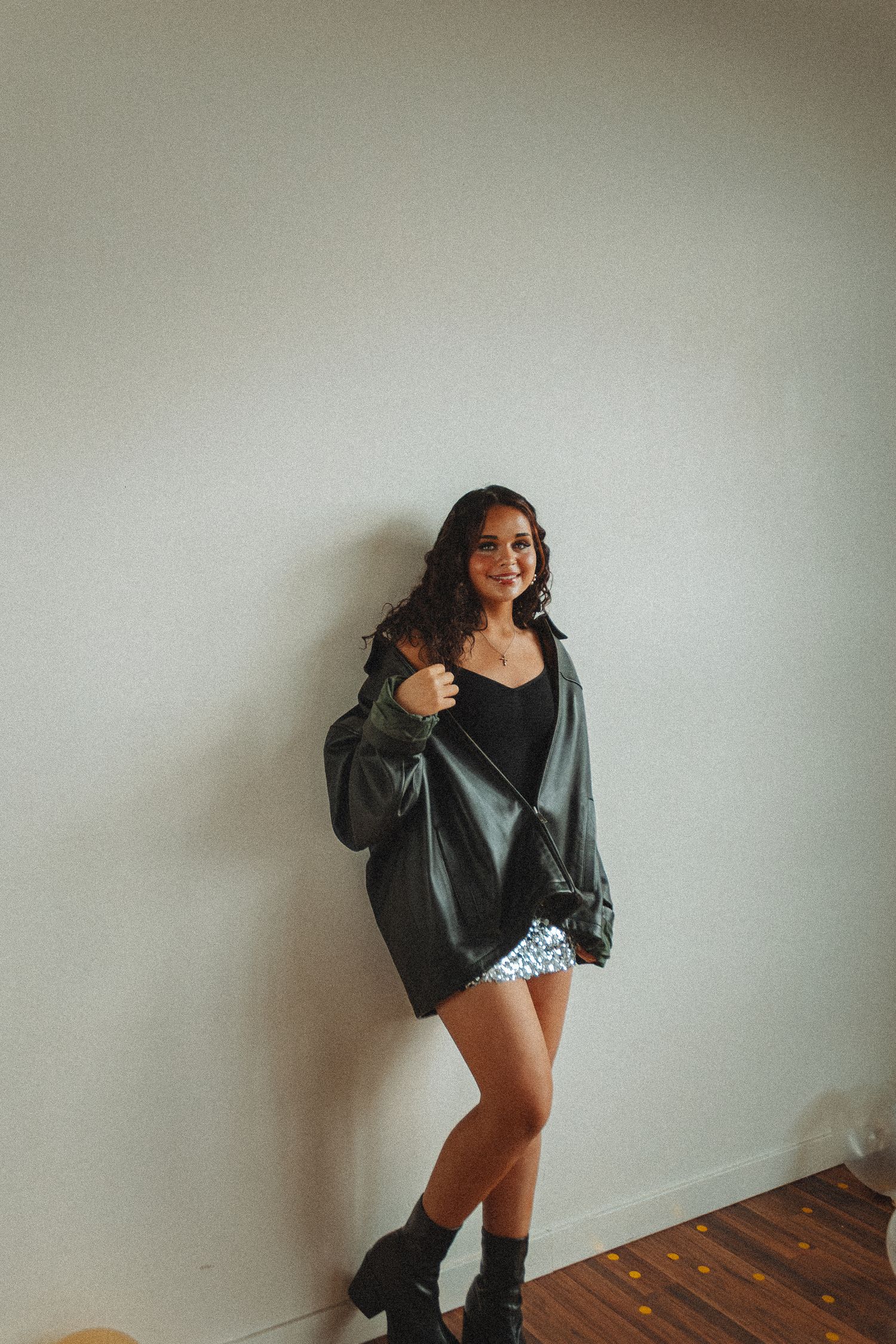 Fashion photo series showing poses in dark sweater against minimal white background.