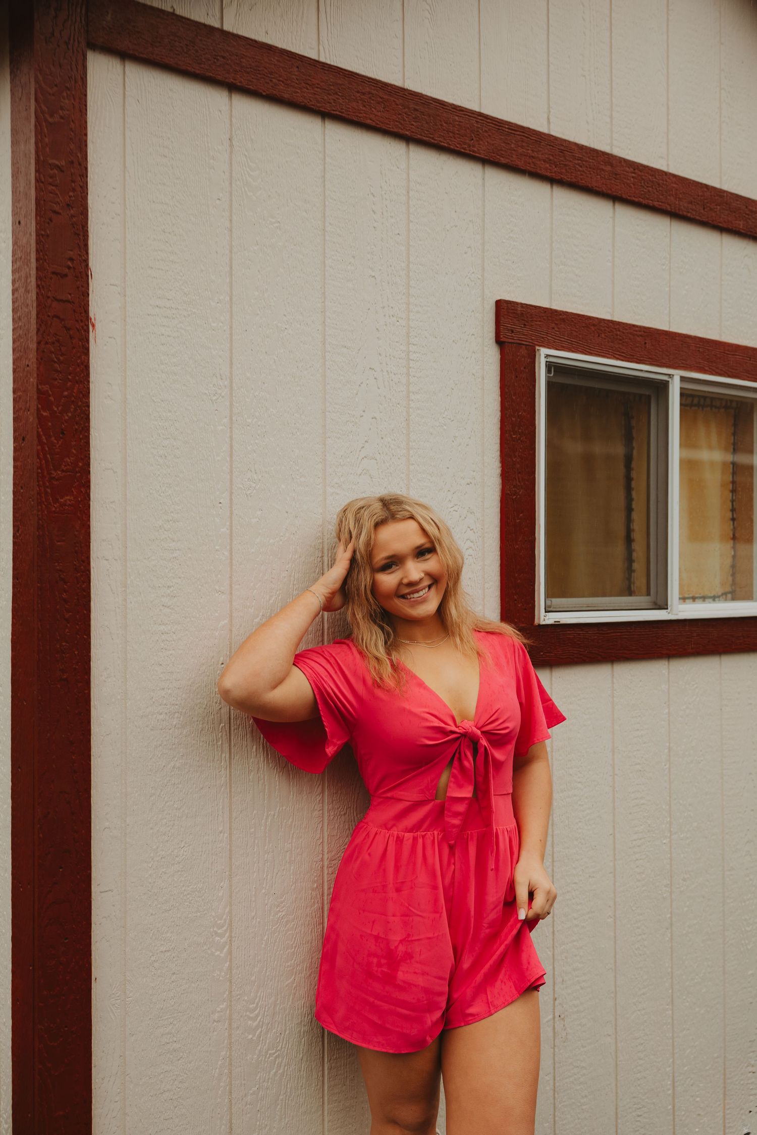 Candid shots of someone in red summer outfit posing against neutral colored building exterior.