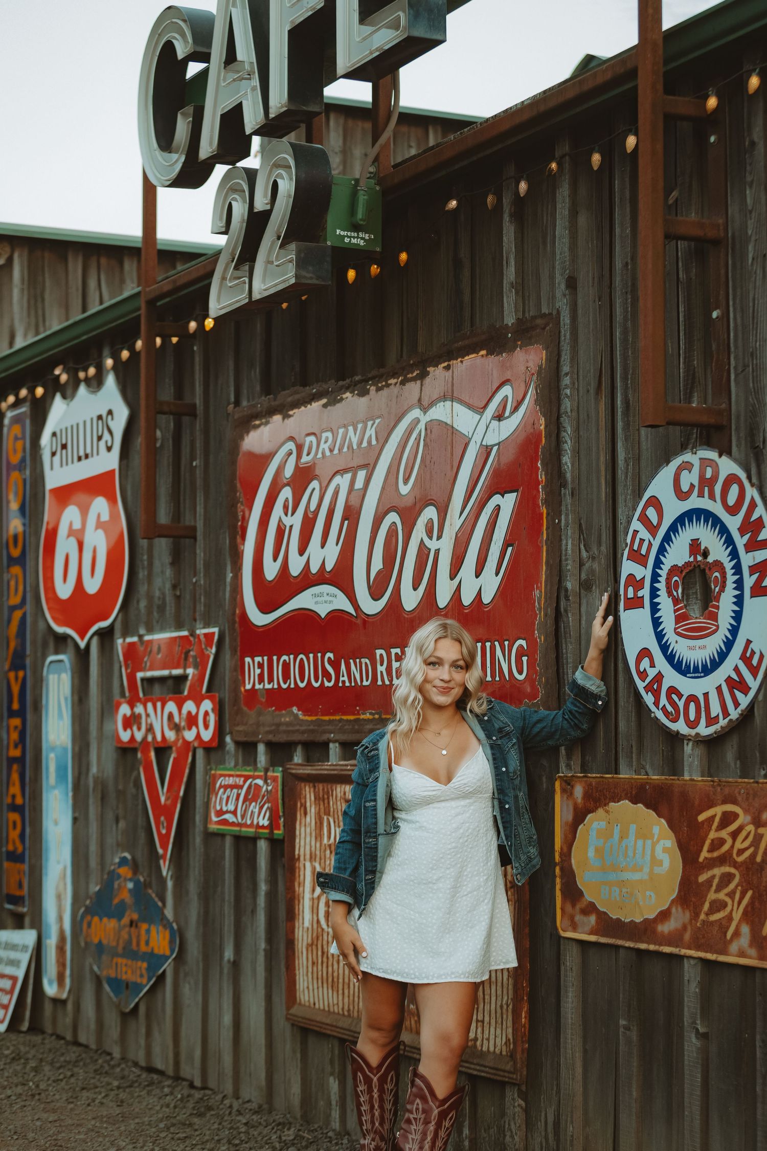Rustic wall display featuring vintage Coca-Cola signs and retro gasoline advertisements.