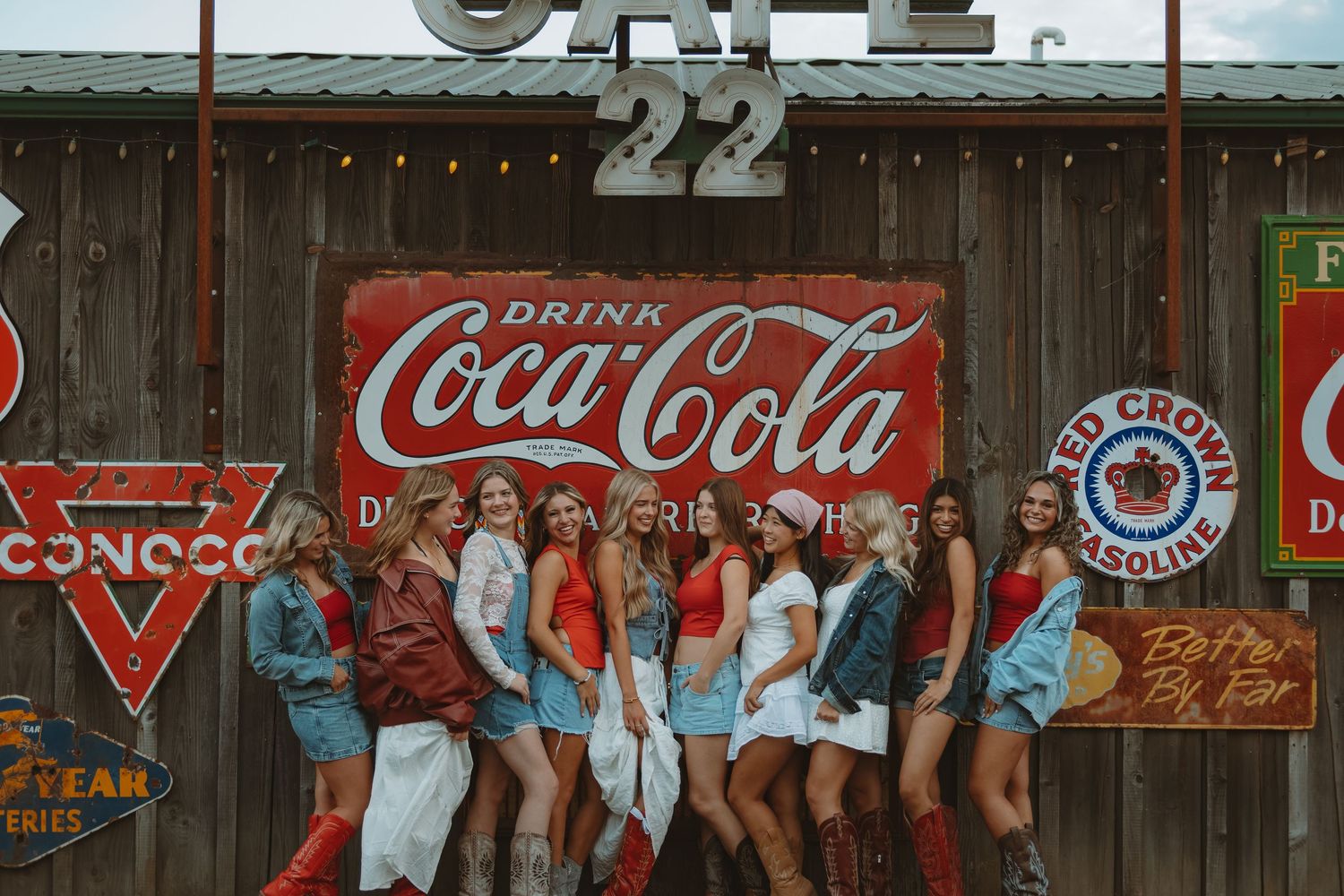 A long wooden wall adorned with classic Coca-Cola advertisements and vintage signage.