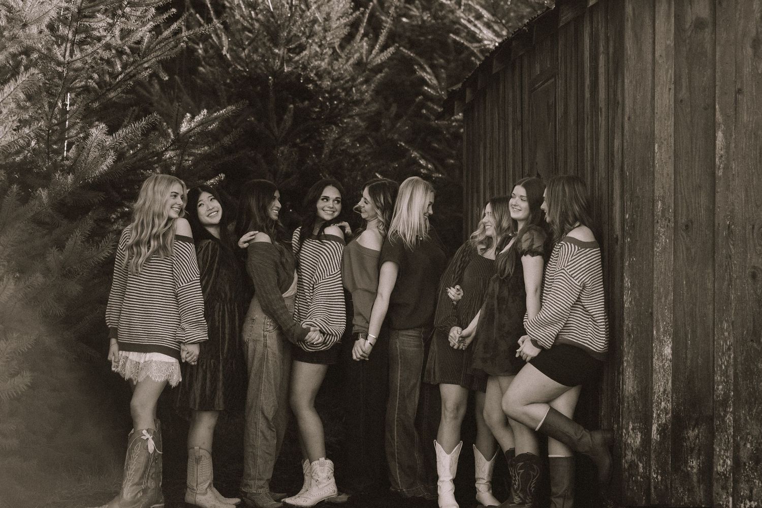 A group gathers in front of a rustic wooden barn during golden hour creating a festive atmosphere.