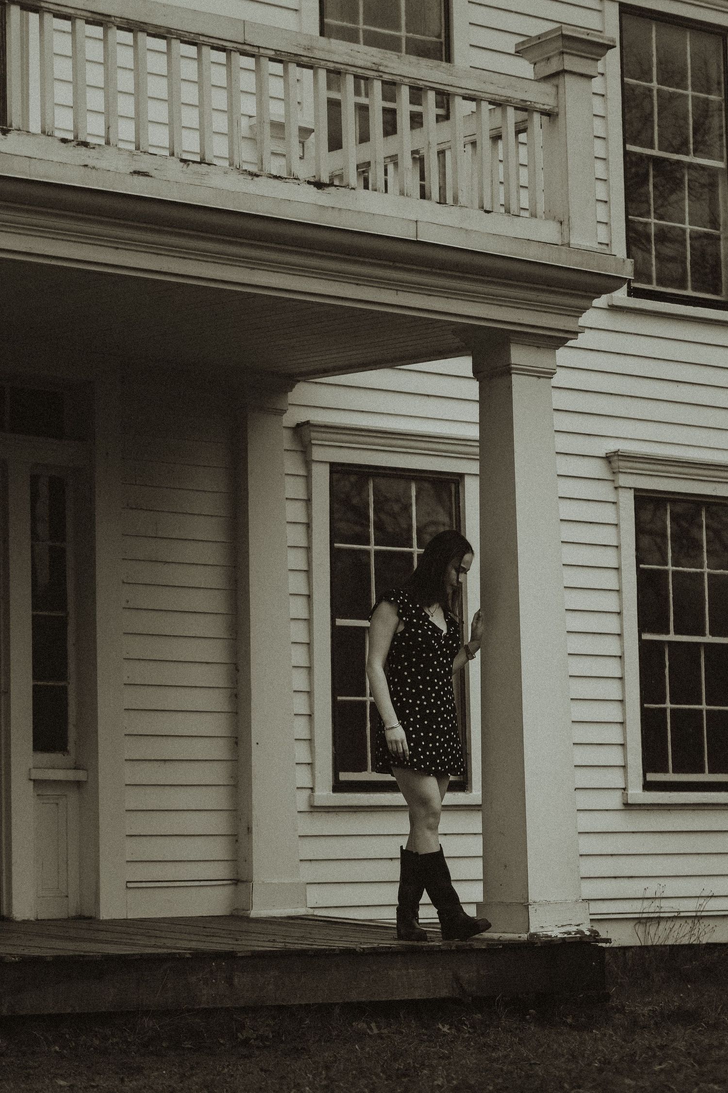 A sequence of black and white photos showing someone in a polka dot dress walking through a doorway of a white house.