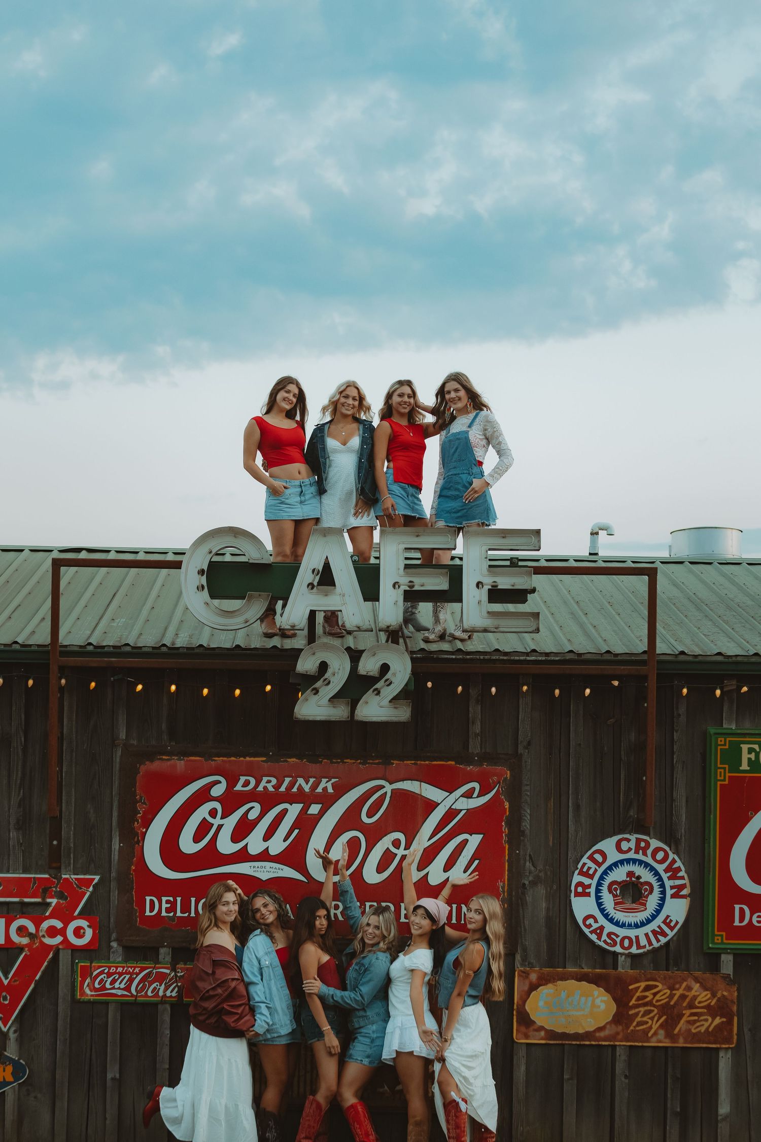 Rustic cafe facade featuring classic Americana signage and vintage Coca-Cola advertisements.