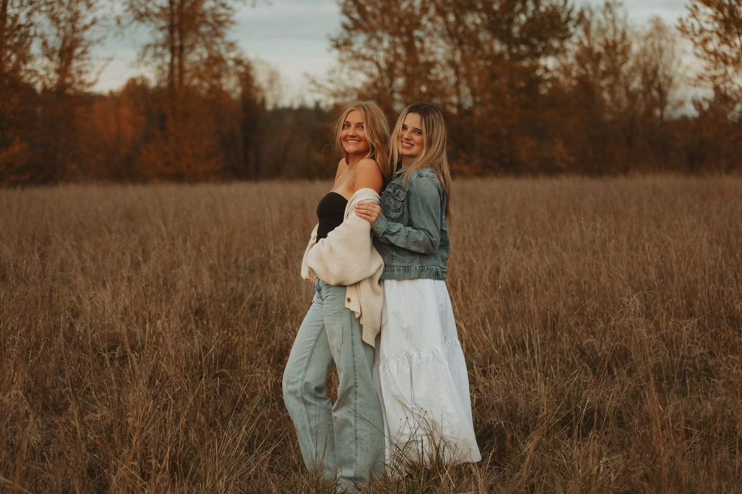 Candid moments captured in a rustic field with autumn colors and denim fashion.