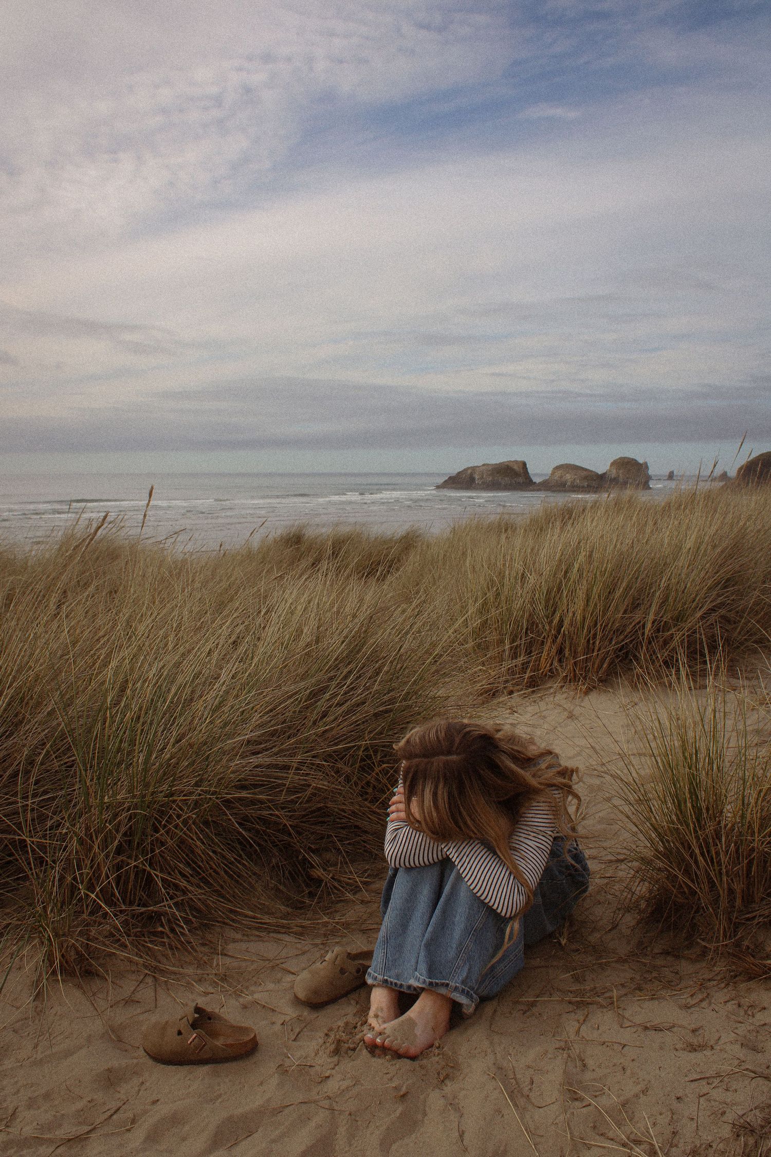 A series of beach photos showing sand dunes with tall grass against a cloudy sky at the Oregon coast.