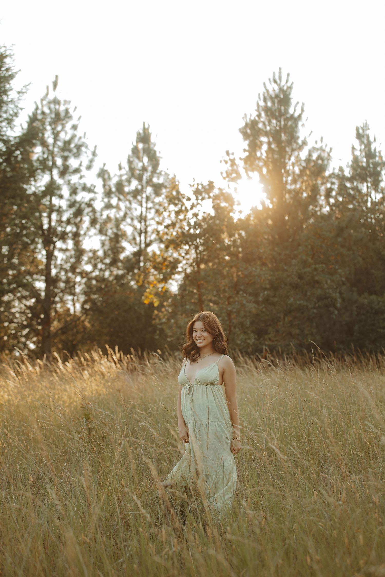 A light sundress flows in the breeze amidst tall grass at golden hour.