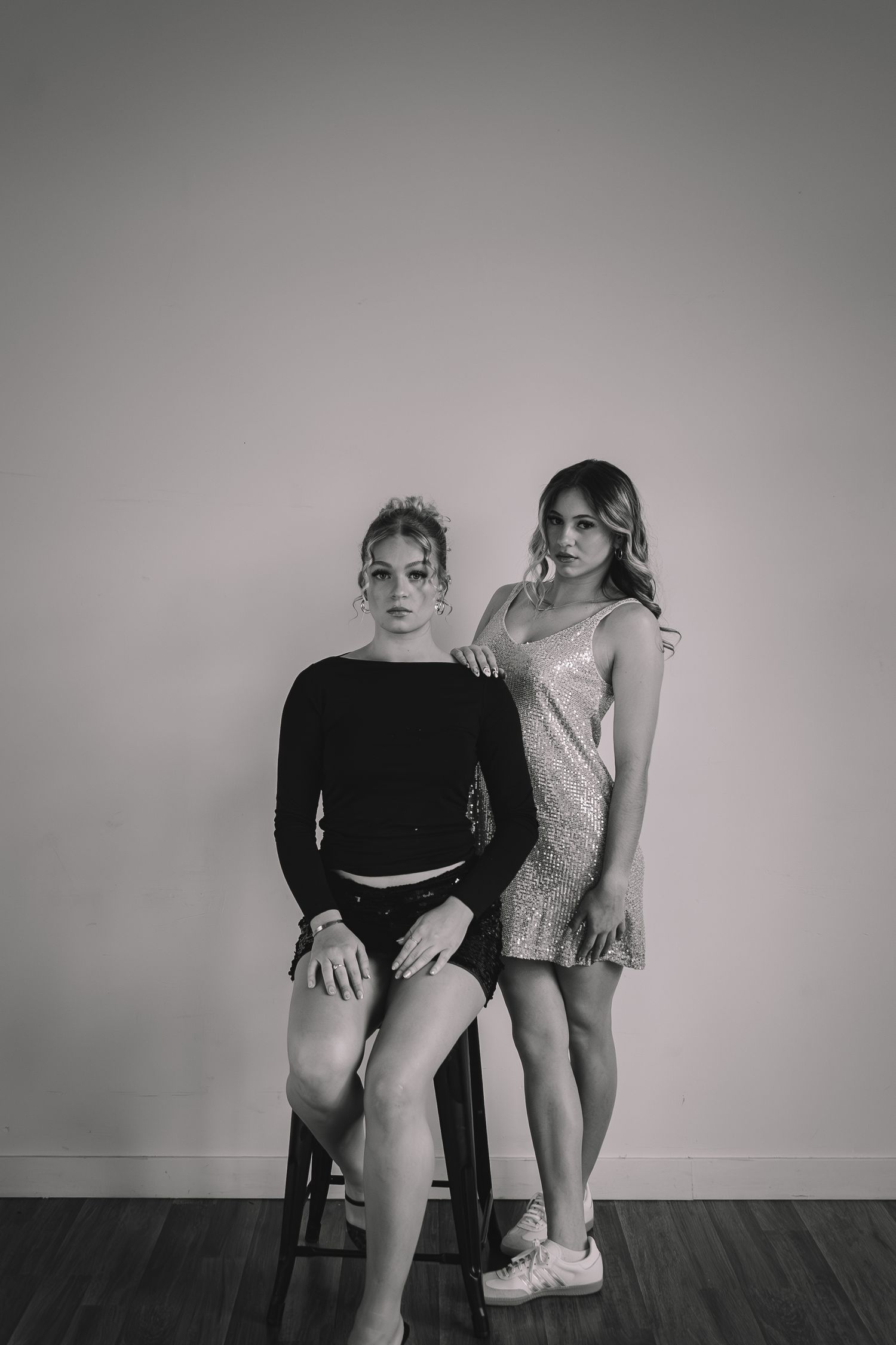 Black and white portrait series showing artistic poses against plain background.