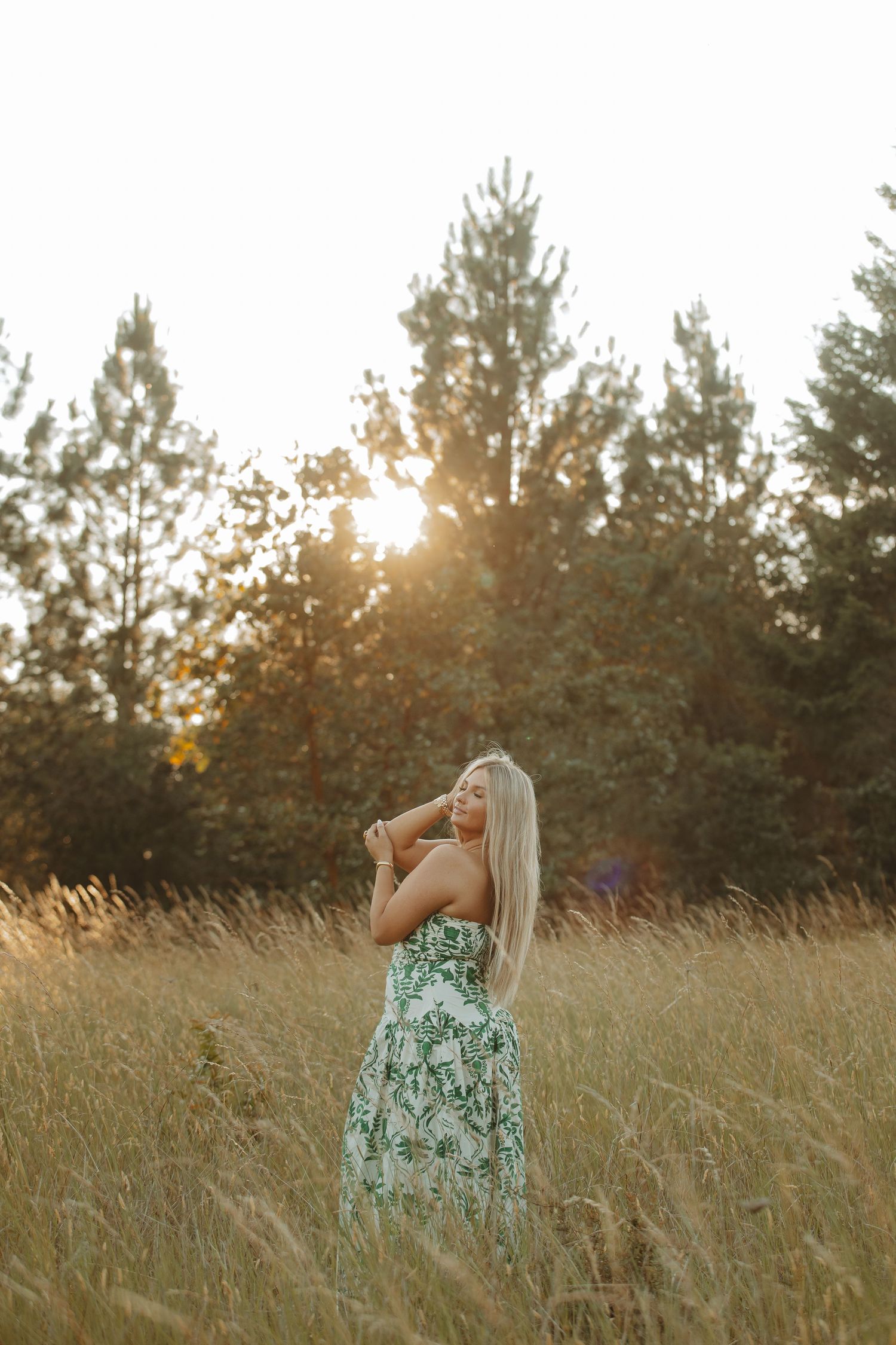 A mint-colored summer dress stands out against warm evening light in a grassy field.