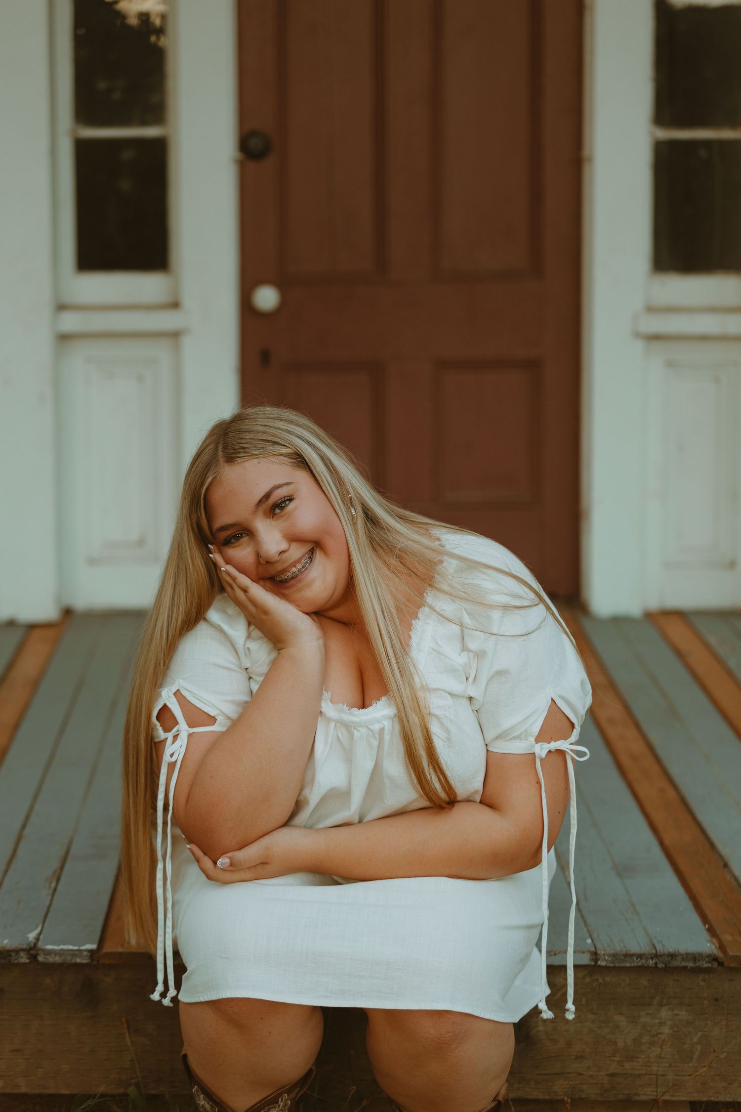 A series of four photos showing someone in a white dress lying on a wooden porch in different relaxed poses.