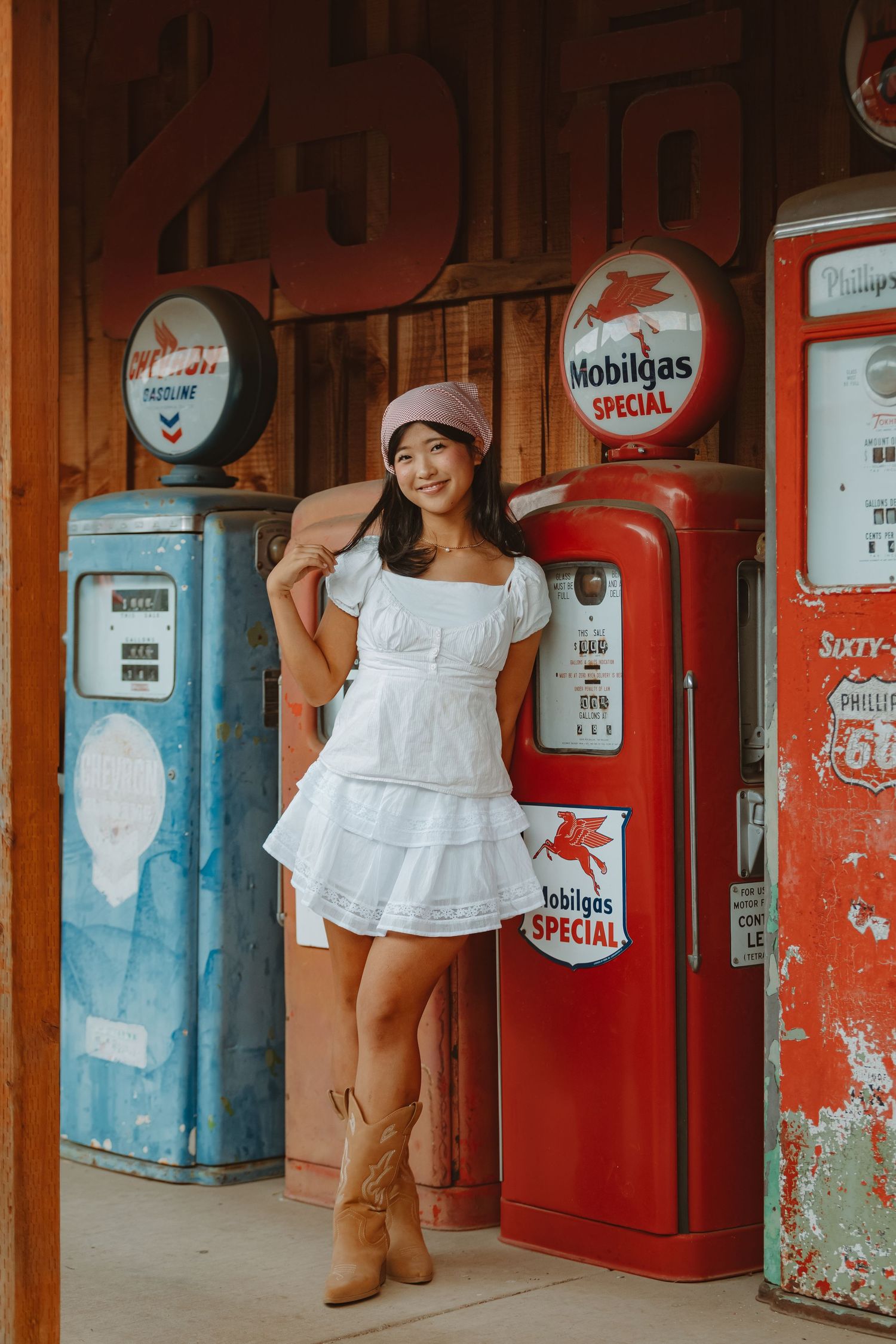 White summer dress and boots styled for vintage gas station photoshoot.