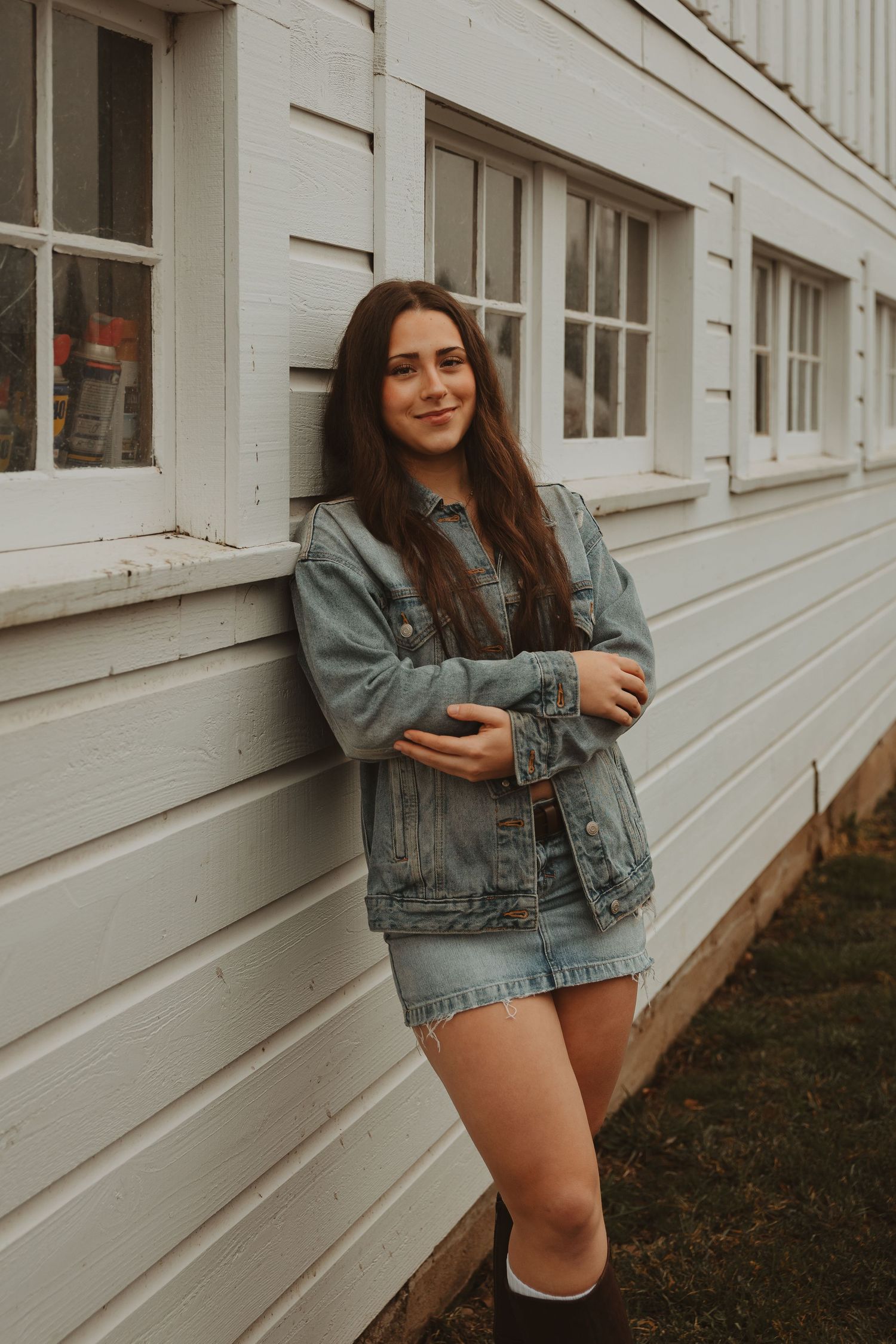 Casual fashion poses against a white exterior wall showcasing denim and summer style.