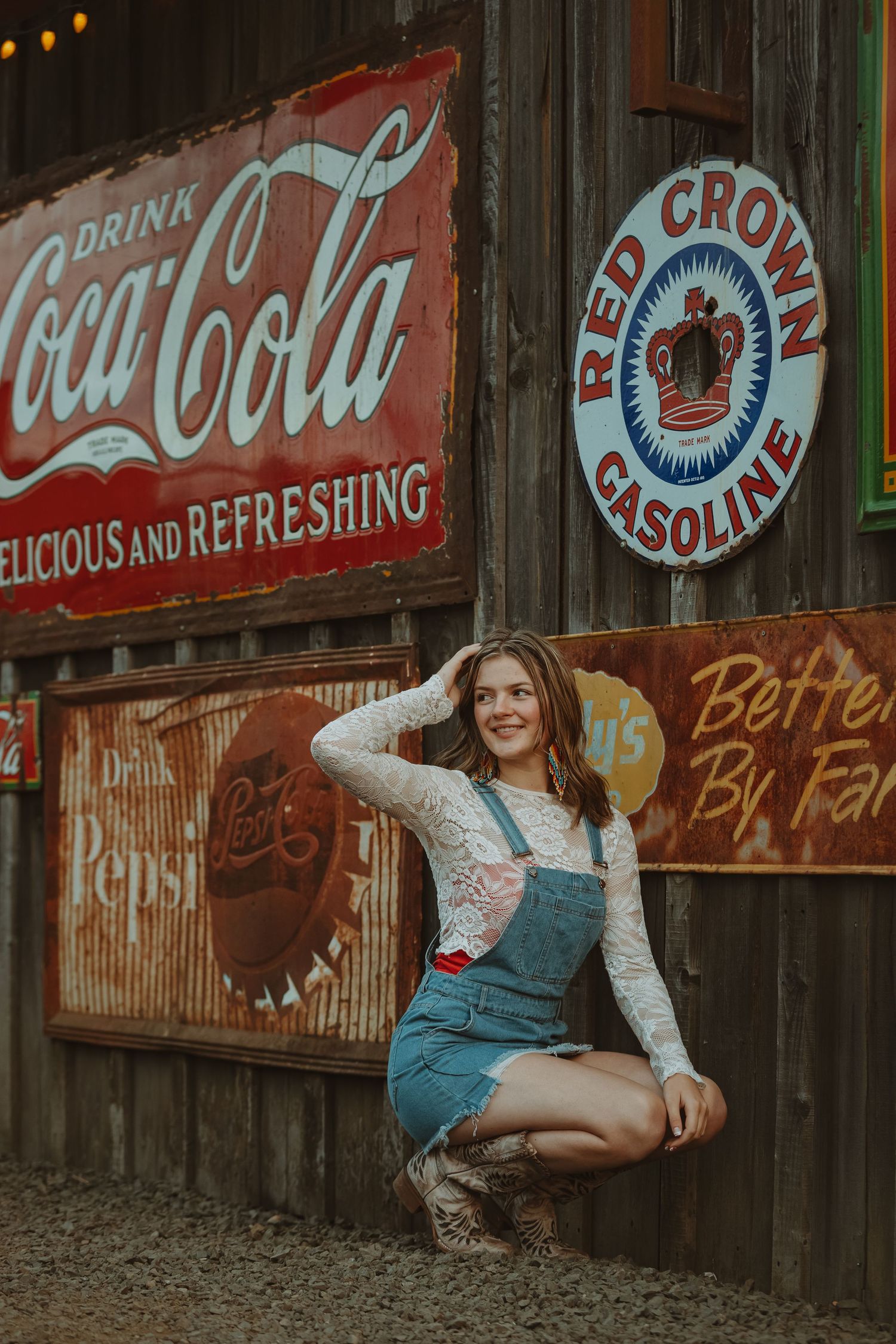 Vintage-style portrait against weathered wall with classic Coca-Cola and Red Crown Gasoline signage.