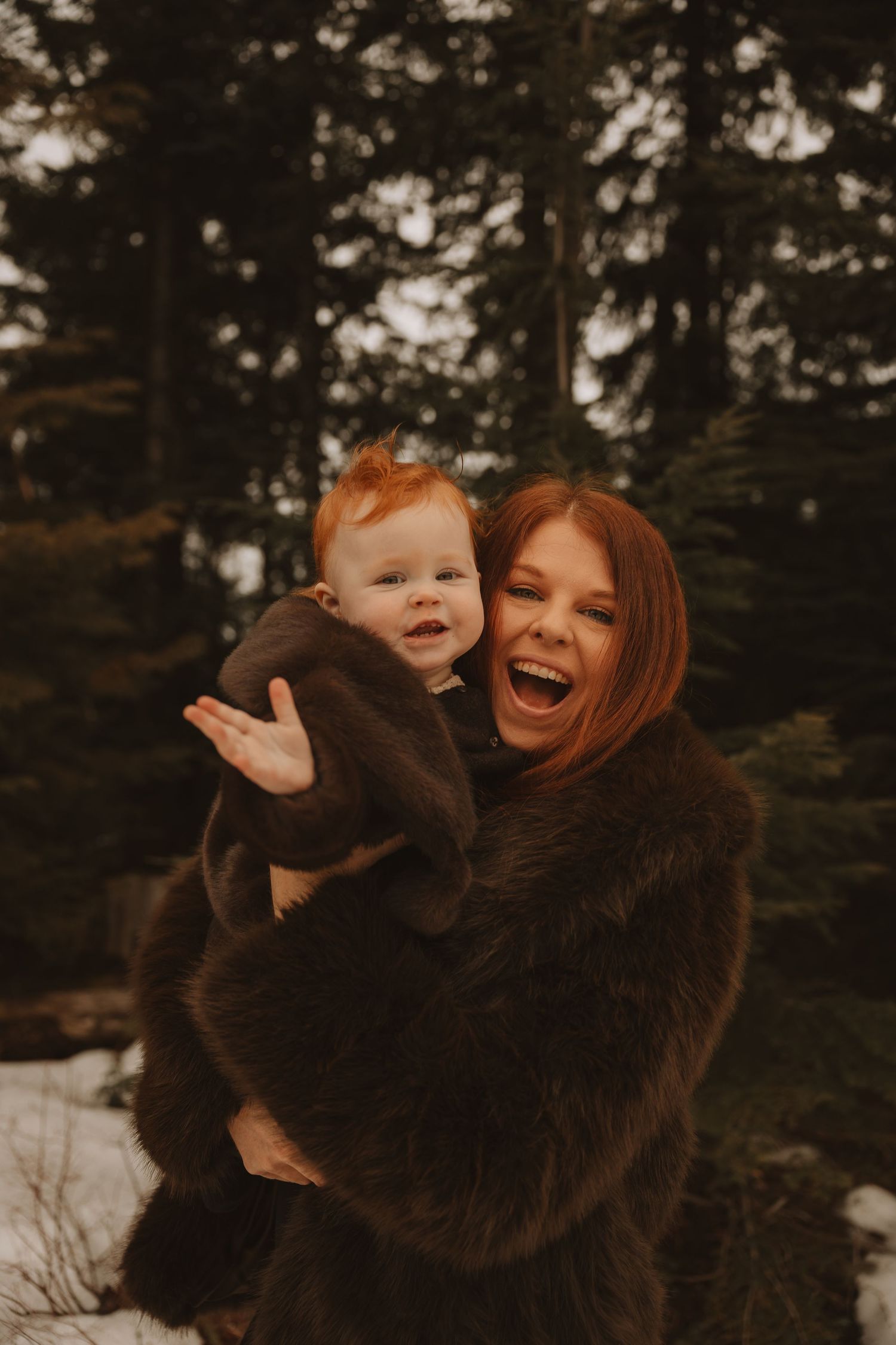 A joyful moment captured in a series of candid shots in a dark wooded setting during winter.