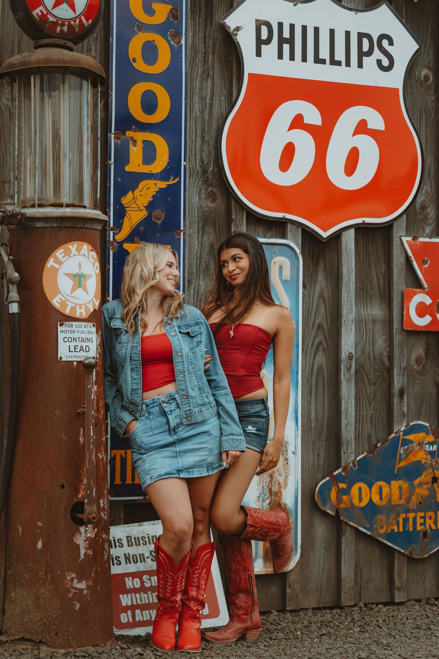 Classic Phillips 66 and automotive signs create vintage americana atmosphere on rustic wall.