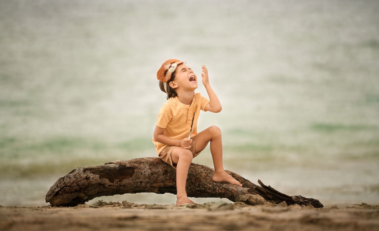 5-year-old boy playing in the sand during a beach session by a Houston children photographer.