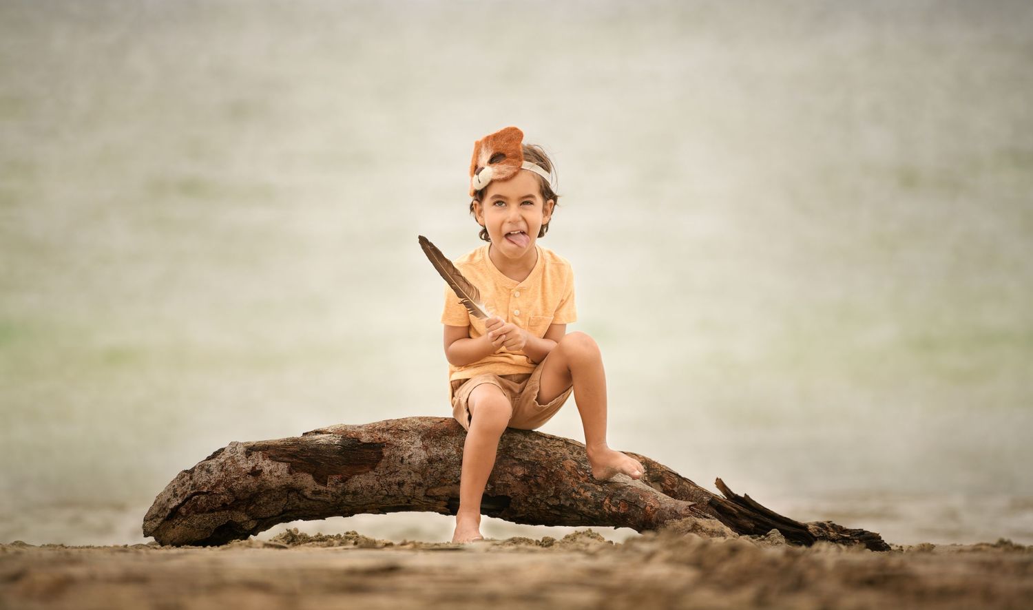 Candid portrait of a young boy at the beach photographed by a Houston family photographer.