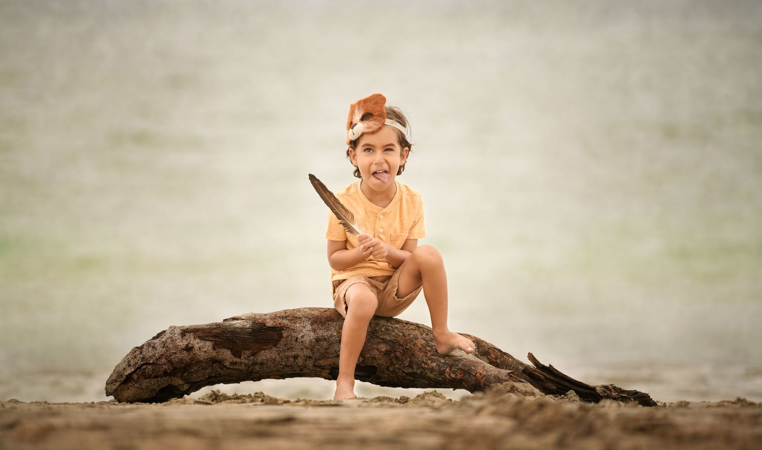 Candid portrait of a young boy at the beach photographed by a Houston family photographer.