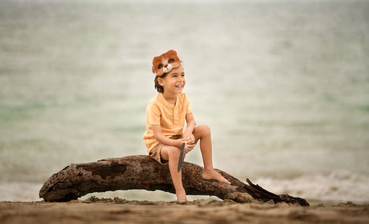 Photo of boy capturing authentic childhood moments during a Houston beach photography session.