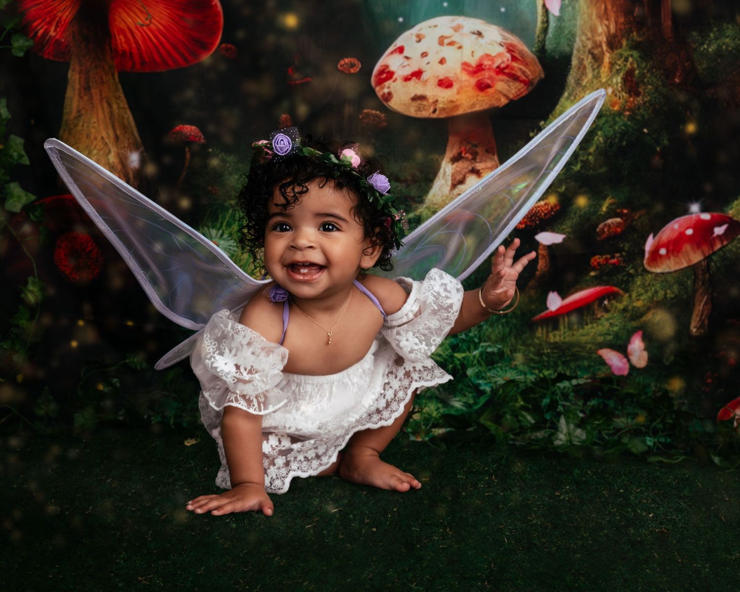 Fantasy woodland photo shoot with fairy wings and red mushrooms in a magical forest scene.