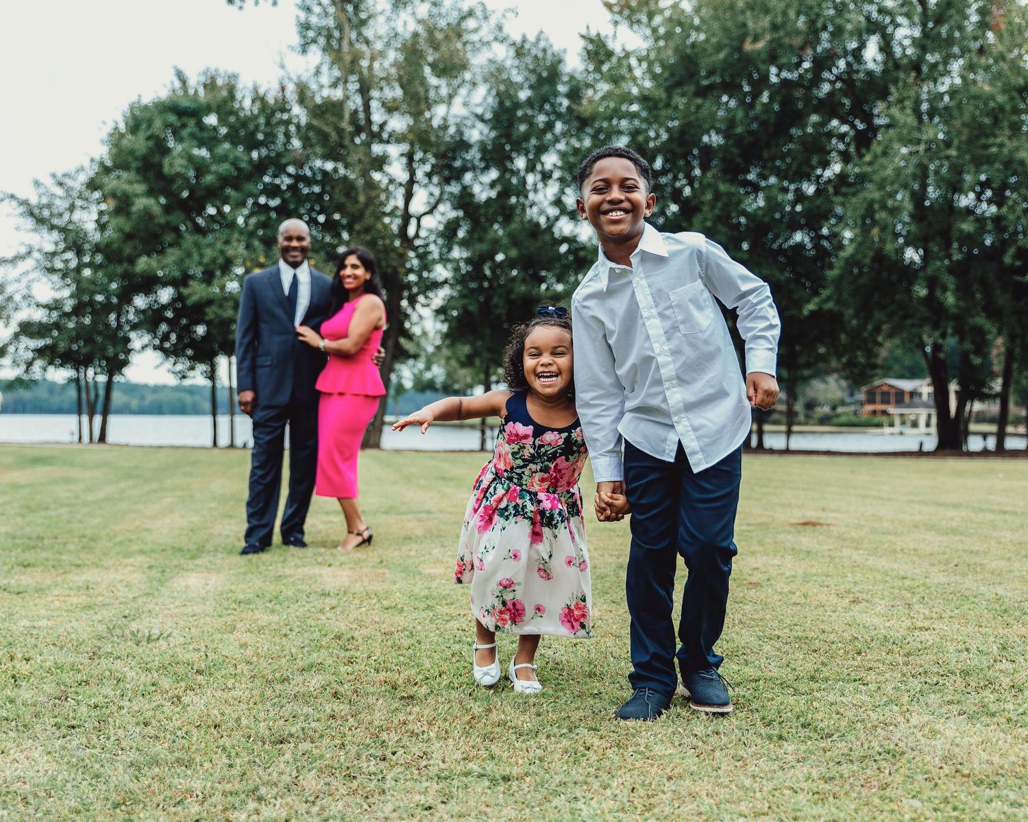 Family celebrating together in a sunny outdoor park setting.