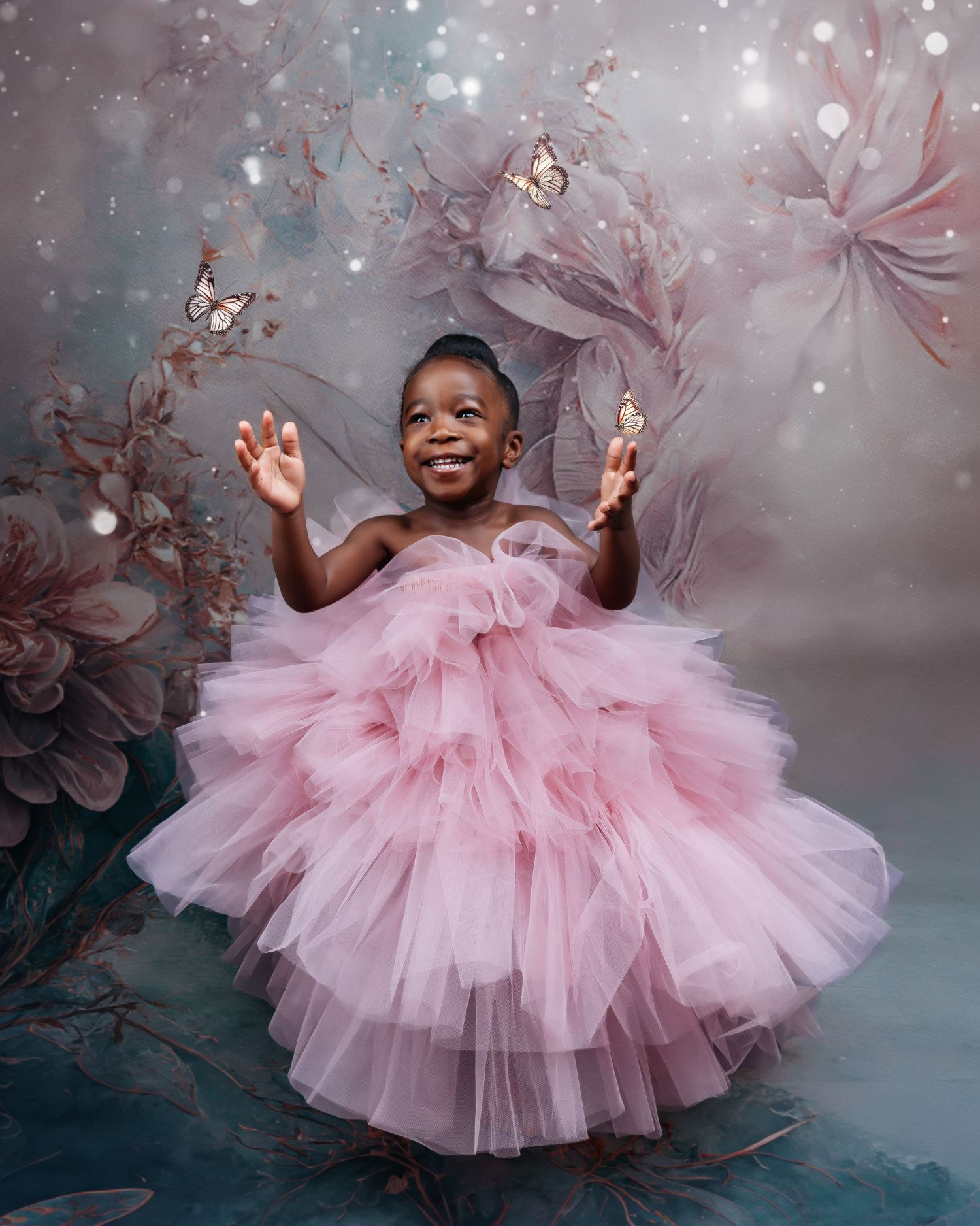 Child in pink tulle dress twirling against dreamy floral background.