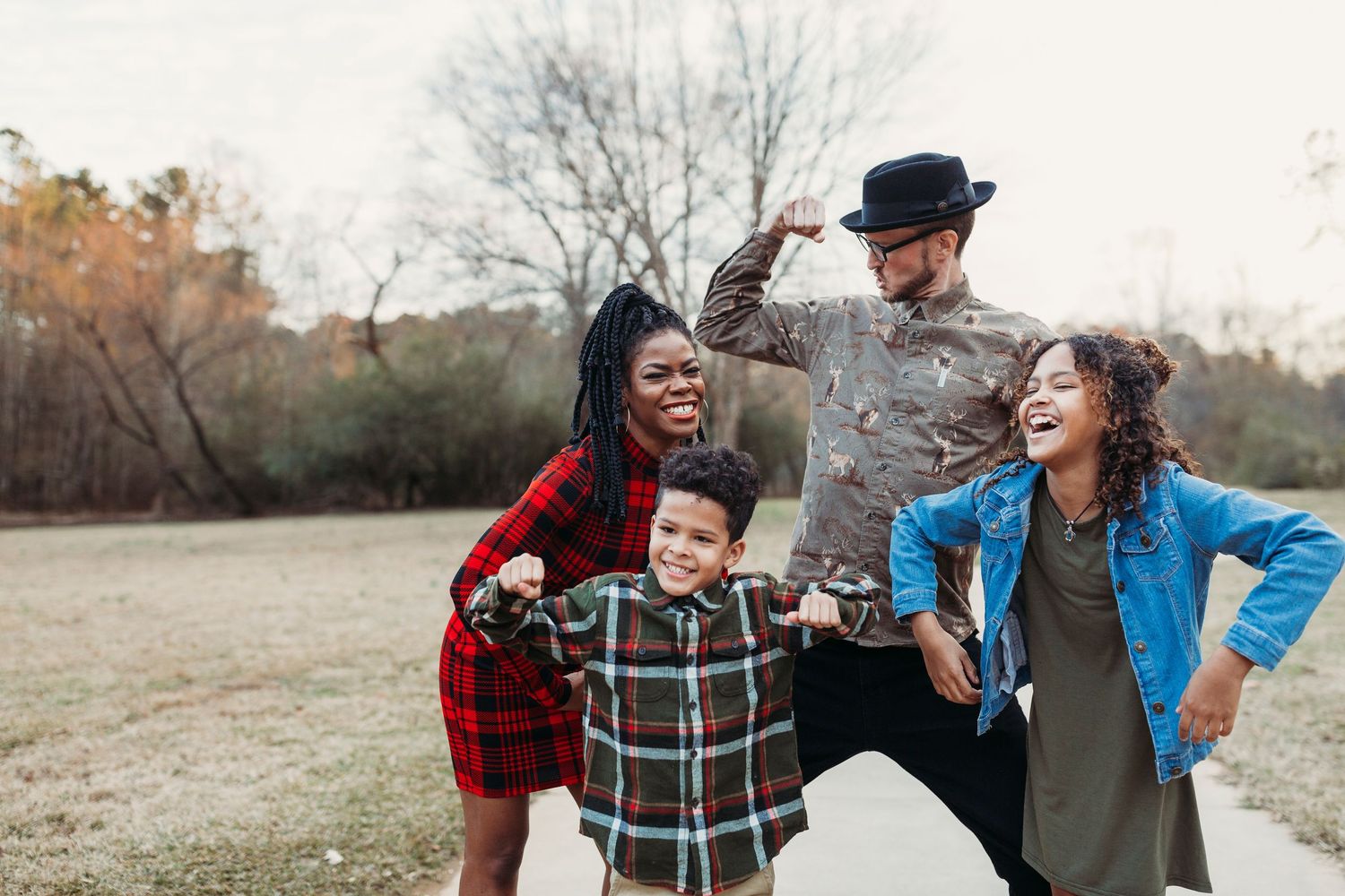 A playful family moment captured outdoors with everyone laughing and having fun together.