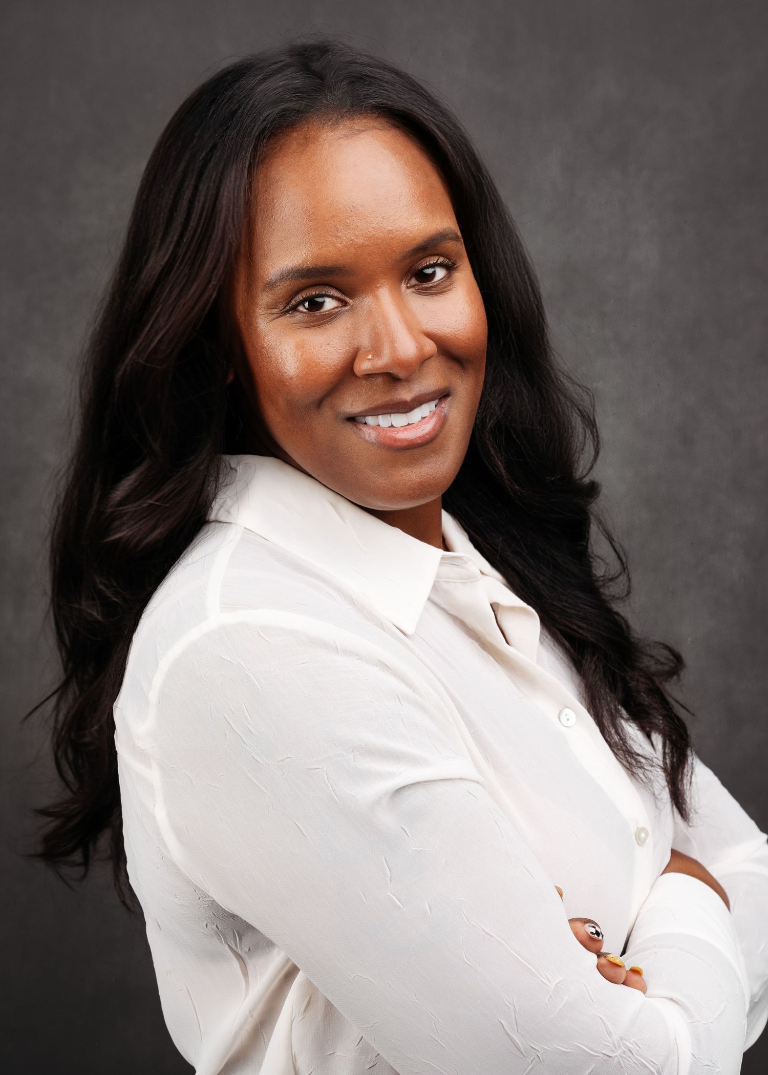 Studio portraits showing a person in a crisp white button-down shirt against a dark background.