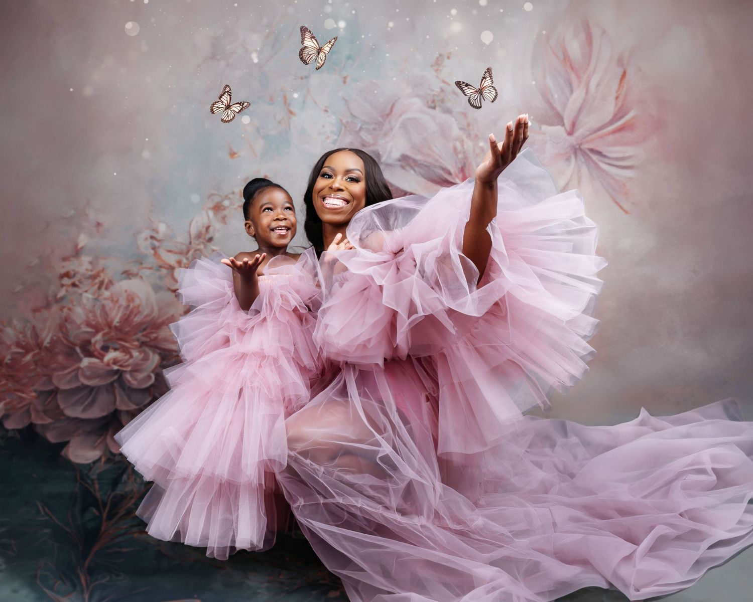 Dreamy pink tulle gowns flow across a soft ethereal backdrop with delicate butterflies.