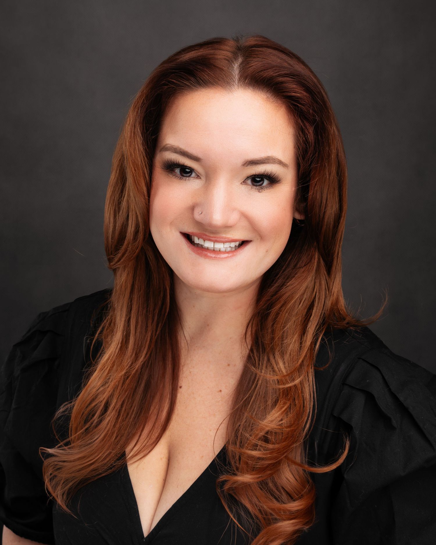 Professional portrait series featuring warm lighting and black background.