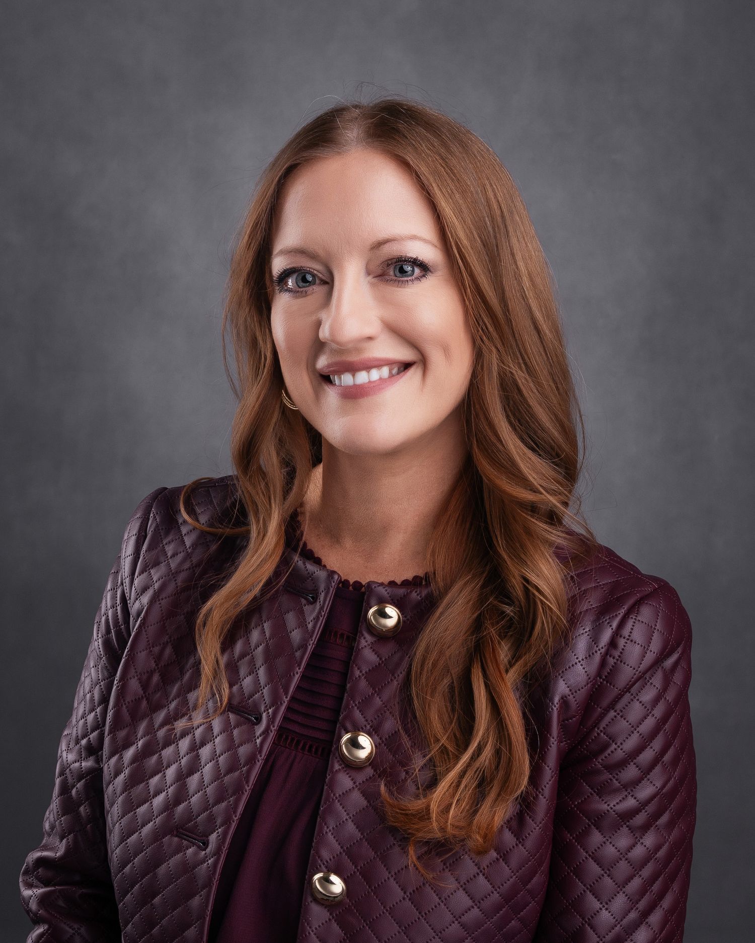 Professional headshots of woman in burgundy quilted jacket against dark background.