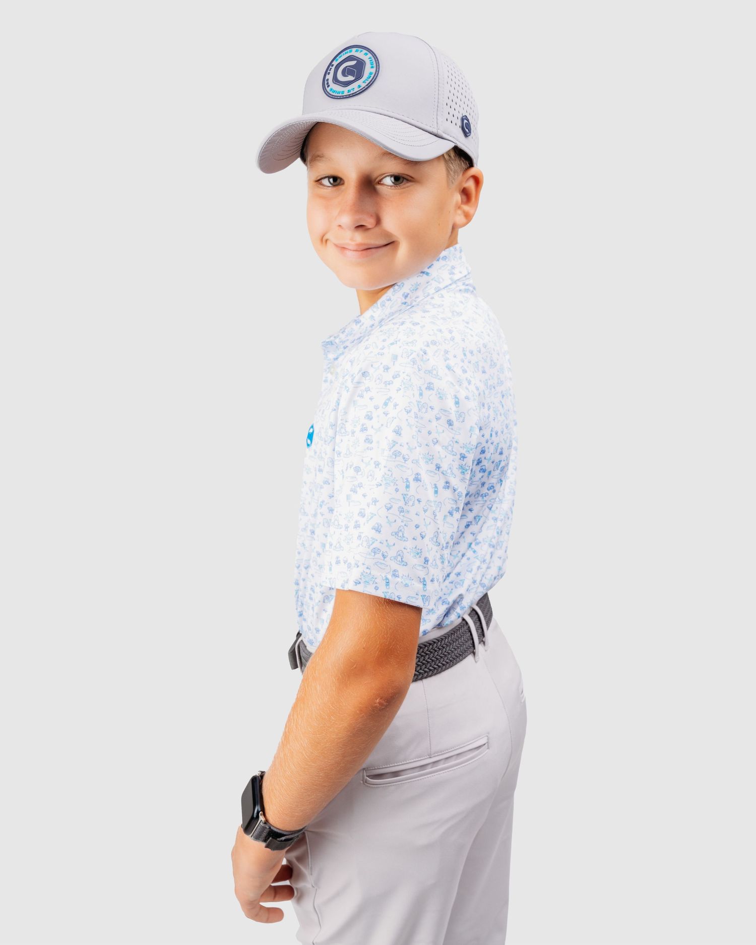 Golf attire featuring a white polo shirt, blue cap, and light colored pants.