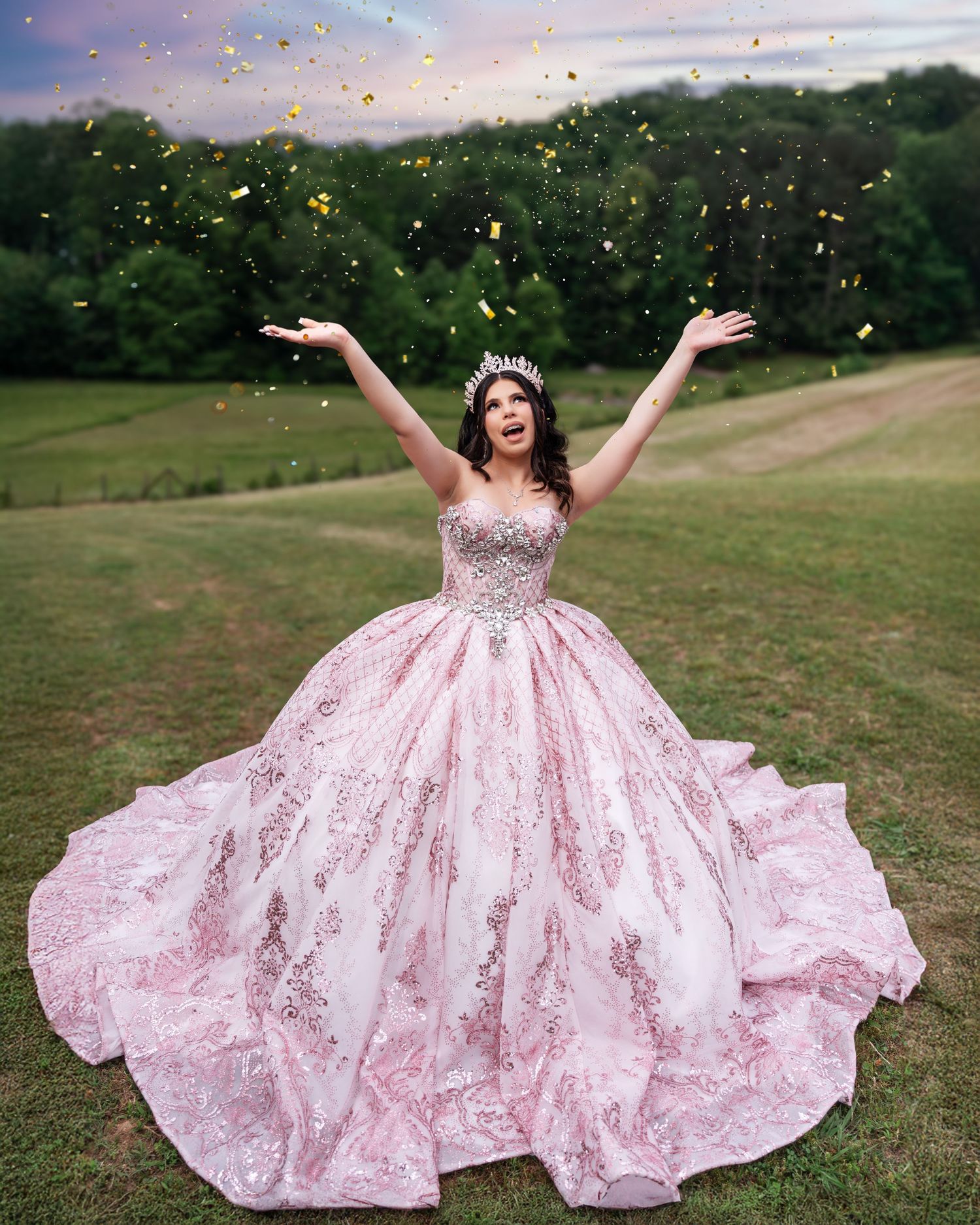 A celebratory moment in a pink ball gown with glitter and confetti against a sunset sky.